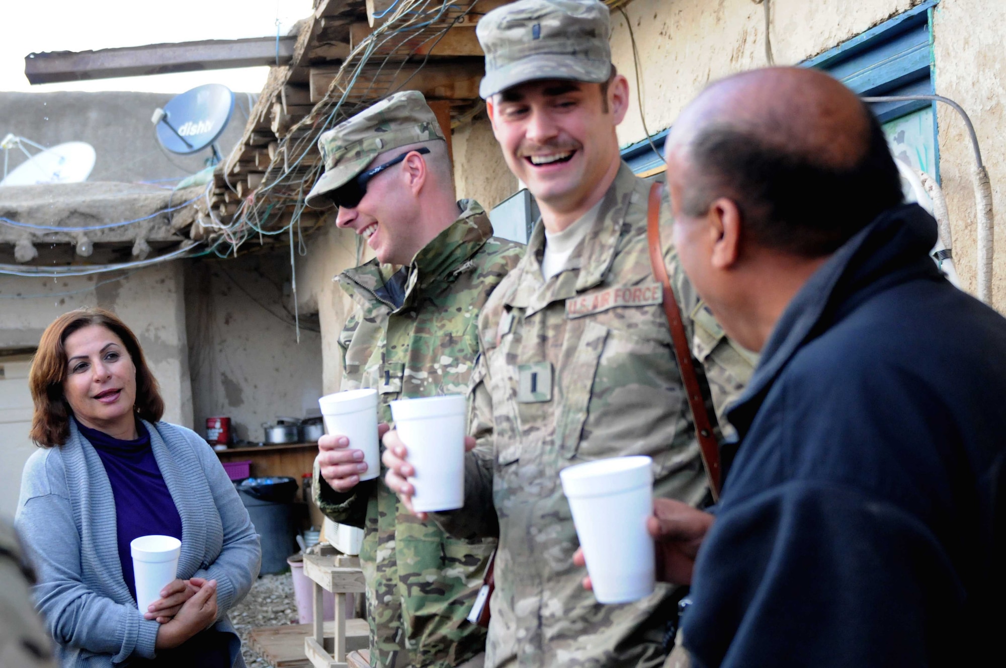 Shakila Zikeria, a cultural advisor from Sacramento Calif.,1st Lt. Eric Ozburn, information operations officer from Rowland Heights, Calif., 1st Lt. Ryan Mills, intelligence officer from Chicago and Assdullah Fazily, a cultural advisor from Las Vegas, share a cup of tea at Forward Operating Base Gardez Nov. 8, 2011. (U.S. Air Force photo/1st Lt. Cammie Quinn)