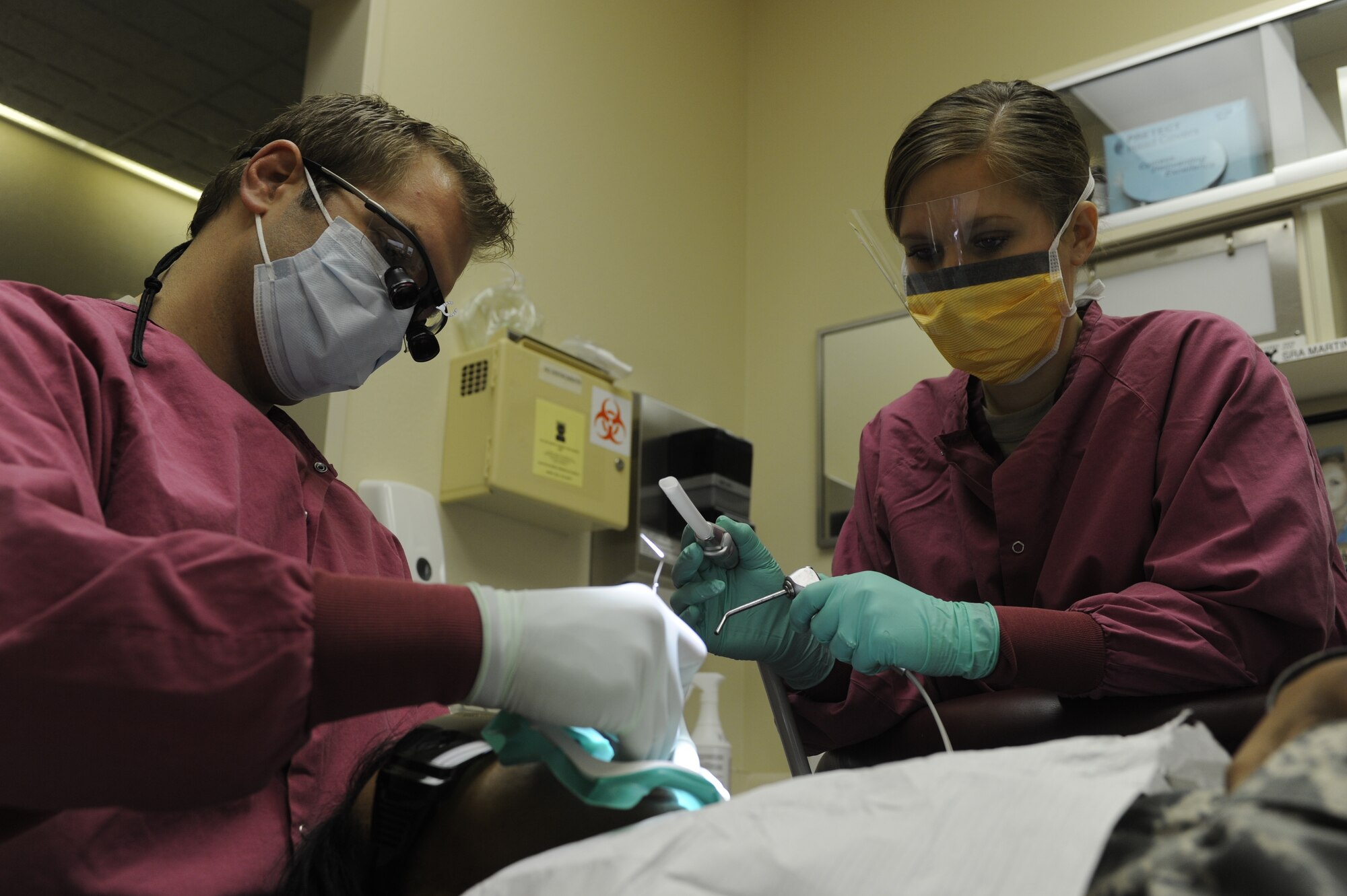 MINOT AIR FORCE BASE, N.D. -- Capt. Glenn Ashworth, 5th Medical Operations Squadron dentist, and Senior Airman Ashley Martin, 5th Medical Operations Squadron dental assistant, perform a root canal on a patient here Nov. 3. Teamwork is essential in allowing dentists to concentrate completely on the task at hand. (U.S. Air Force Photo/Airman 1st Class Stephanie Ashley)
