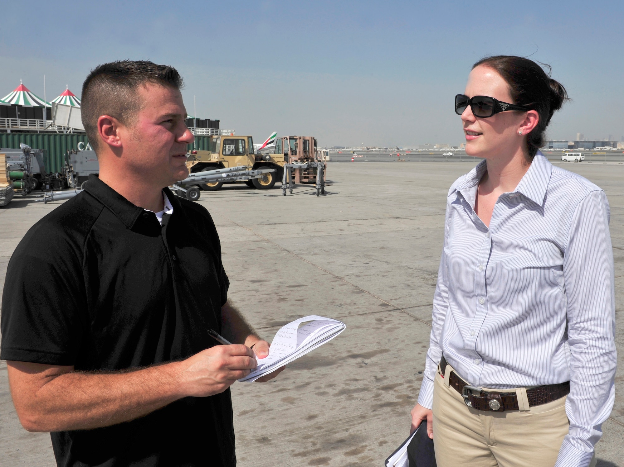 Master Sgt. Chance Babin 380th Air Expeditionary Wing public affairs superintendent interviews Capt. Julia Palmer 380th AEW Maintenance Squadron lead. Capt. Palmer is responsible for military aircraft positioning and over all airfield operations for the Airforce portion of the 2011 Dubai Airshow.  The Airshow will highlight a variety of U.S. Air Force, Navy and Army aircraft showcasing the range of U.S. military airpower capabilities. Aircrew and support personnel from bases in the gulf region, Europe and the U.S. are participating in the event, which is expected to draw more than 55,000 visitors.  (U.S. Air Force Photo/Tech. Sgt. Patrick Mitchell)