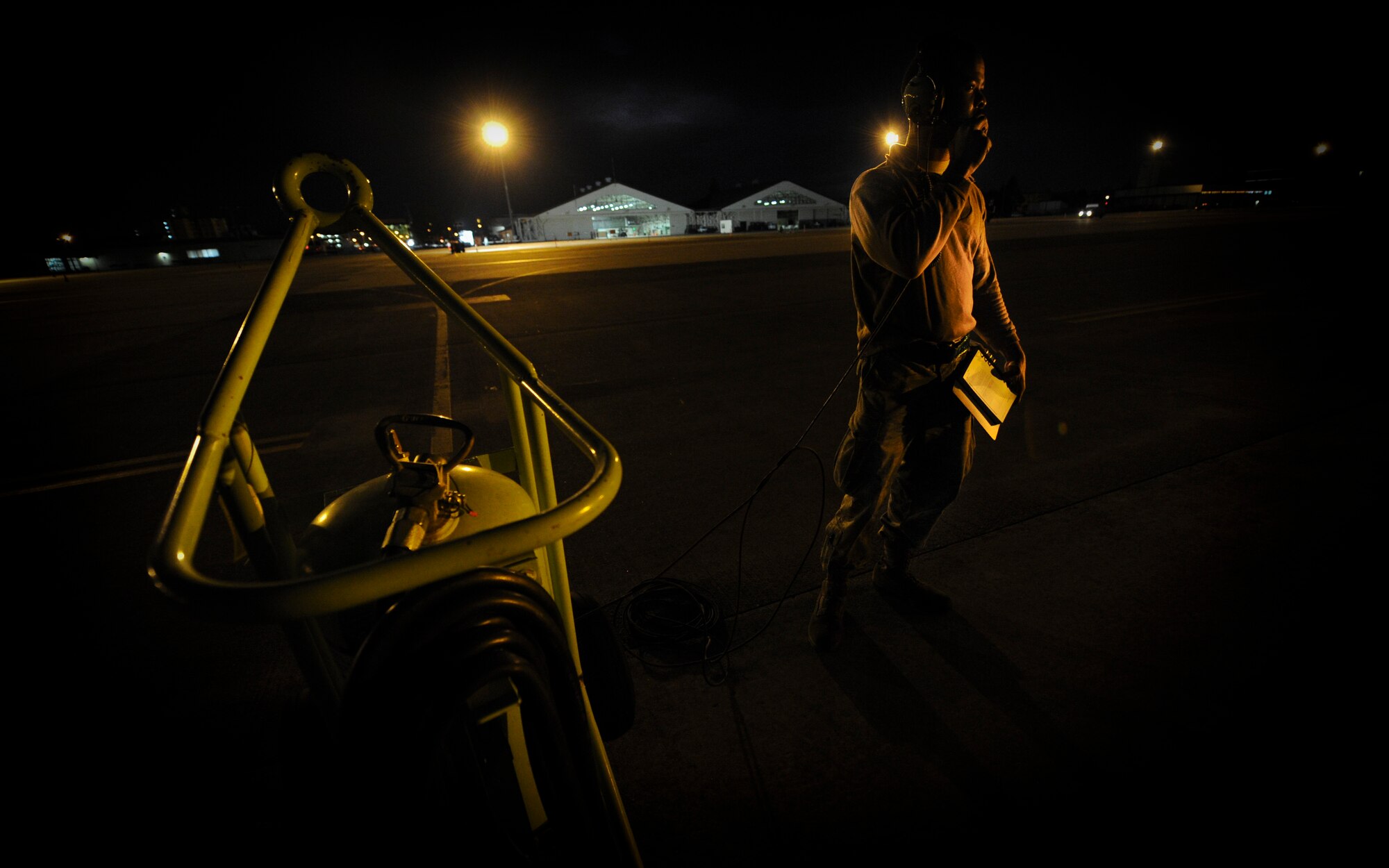 YOKOTA AIR BASE, Japan -- Staff Sgt. Travis Bland 374th Aircraft Maintenance Squadron supervises and talks to his co-workers while they refuel a C-130 during a operational readiness inspection at Yokota Air Base, Japan, Nov. 8, 2011. The ORE tests Airmen's knowledge and ability in a variety of areas in both the peacetime and wartime mission. (U.S. Air Force photo/Staff Sgt. Stacy Moless)