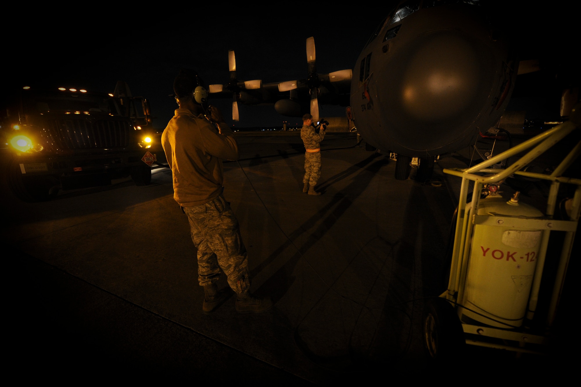 YOKOTA AIR BASE, Japan -- Staff Sgt. Travis Bland 374th Aircraft Maintenance Squadron supervises and talks to his co-workers while they refuel a C-130 during a operational readiness inspection at Yokota Air Base, Japan, Nov. 8, 2011. The ORE tests Airmen's knowledge and ability in a variety of areas in both the peacetime and wartime mission. (U.S. Air Force photo/Staff Sgt. Stacy Moless)


