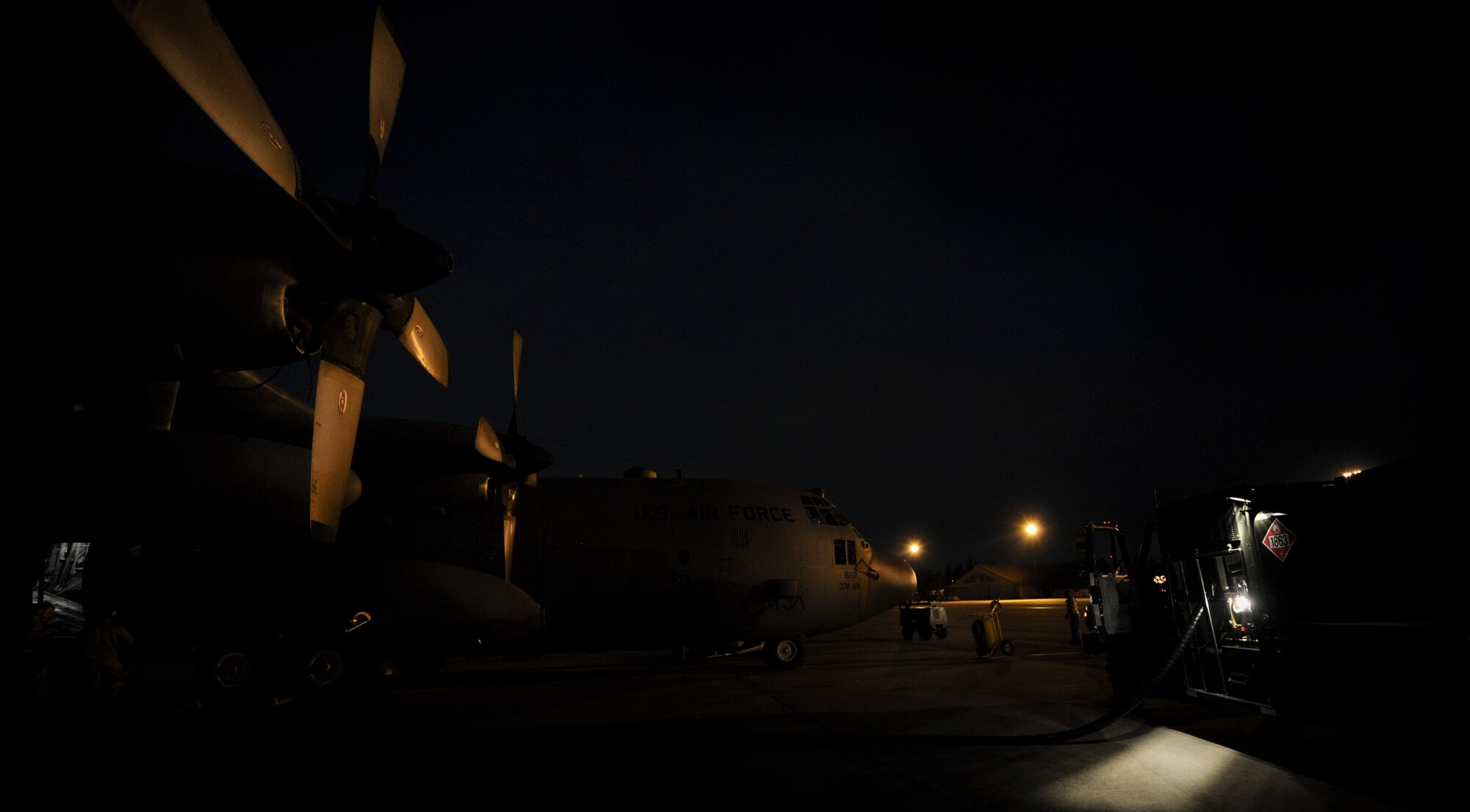 YOKOTA AIR BASE, Japan -- Airman from the 374th Logistics Readiness Squadron, refuel a C-130 during a operational readiness inspection at Yokota Air Base, Japan, Nov. 8, 2011. The ORE tests Airmen's knowledge and ability in a variety of areas in both the peacetime and wartime mission. (U.S. Air Force photo/Staff Sgt. Stacy Moless)

