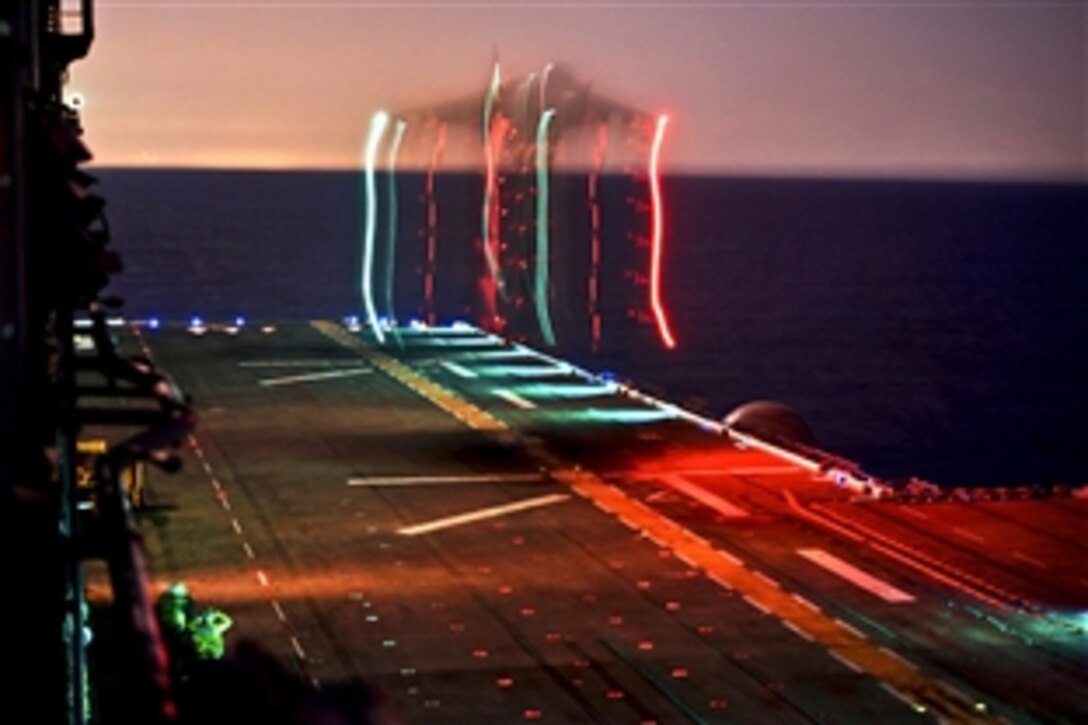 A Marine Corps Harrier AV-8 participates in night time launch and recovery operations on the flight deck of amphibious assault ship USS Bonhomme Richard in the Pacific Ocean, Nov. 7, 2011.