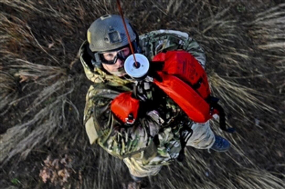 U.S. Air Force Staff Sgt. Robert Colliton is hoisted up to a rescue helicopter during exercise Pacific Thunder near Osan Air Base in South Korea, Nov. 3, 2011. Colliton is a survival evasion resistance escape specialist assigned to the 18th Operation Support Squadron. 