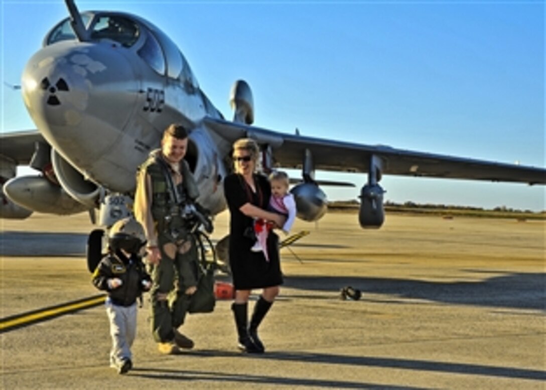 Navy Lt. Chris Rancourt leaves the flight line with his wife and children during a homecoming celebration at Joint Base Andrews Naval Air Facility, Md., Nov. 6, 2011.  Rancourt is assigned to Electronic Attack Squadron 209, which just completed an 85-day forward deployed tour to Afghanistan in support of Operation Enduring Freedom. 