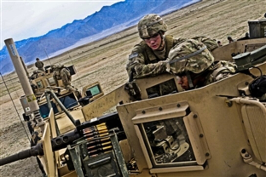 U.S. Air Force Senior Airman Lauren Russell fires the M2 .50-caliber machine gun while Army Spc. Adam Supino looks on near Forward Operating Base Mehtar Lam in Laghman province, Afghanistan, Nov. 7, 2011. Russell and Supino are assigned to the Laghman Provincial Reconstruction Team. They spent the day with fellow team members gaining valuable training time on heavy weapons like the MK-19 and the .50-caliber machine gun.