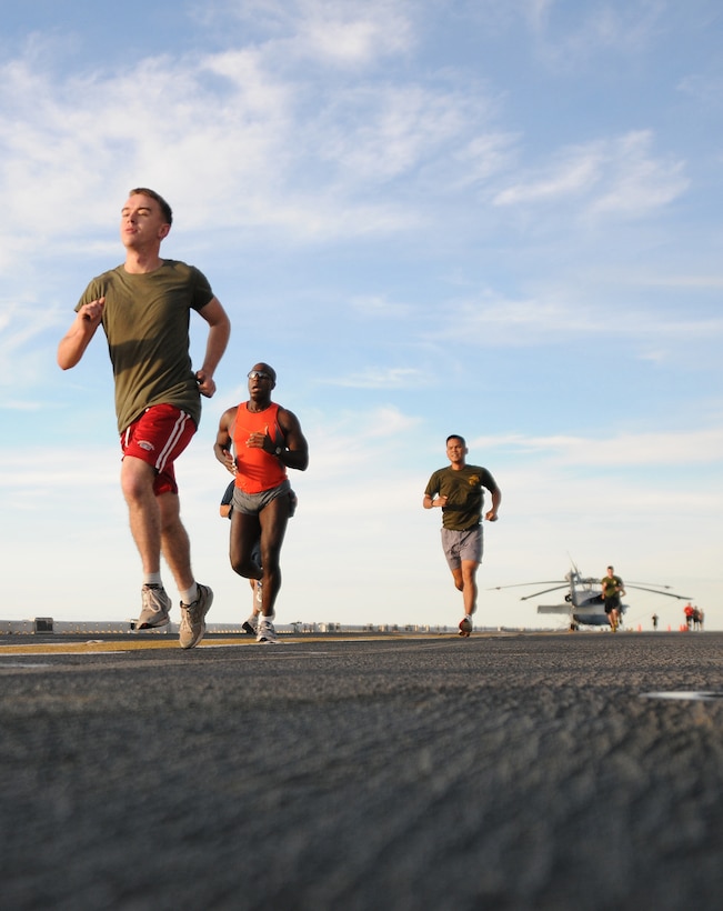 Marines and Sailors of the 31st Marine Expeditionary Unit participate in a Veterans Day fun run on the flight deck of the forward-deployed amphibious assault ship USS Essex (LHD 2).  The 31st MEU is the only continually forward-deployed MEU and remains the United States' force in readiness in the Asia-Pacific region. (U.S. Navy photo by Mass Communication Specialist 2nd Class Spencer Mickler/Released)
