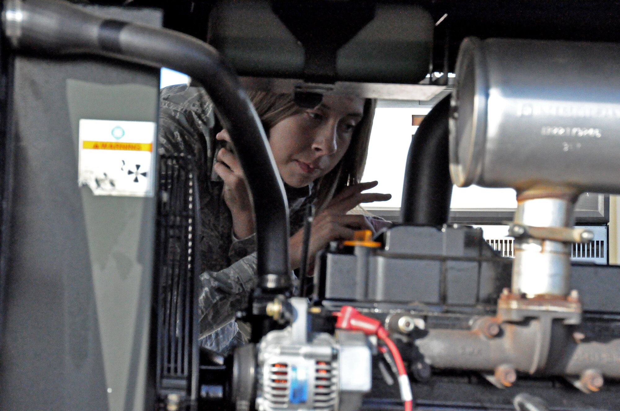 Airman 1st Class Mandy Walden, 60th Maintenance Squadron Aerospace Ground Equipment servicing section, checks a power unit Nov. 4 for foreign object debris such as rocks, plastic and anything else that does not belong. (U.S. Air Force photo/Airman Madelyn Ottem)