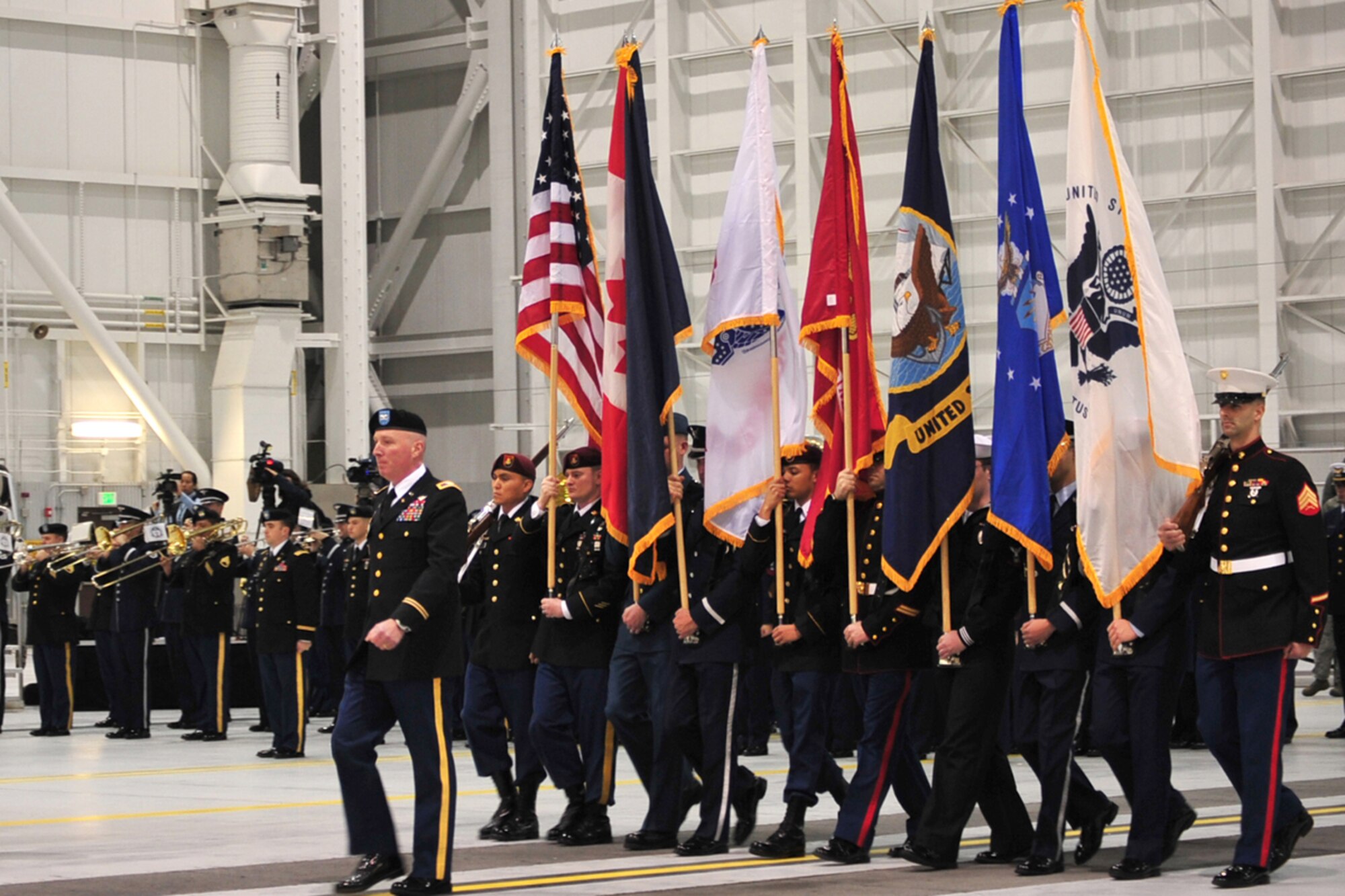 Army Col. Terrance Dolan, commander of troops, leads the color guards during the presentation of colors during the Alaskan Command, Eleventh Air Force, Alaskan North American Aerospace Defense Command Region and Joint Task Force Alaska change of command at Hangar 20 on Joint Base Elmendorf-Richardson, Alaska, Nov. 7. Dolan is the Chief of Staff of Alaskan Command. (U.S. Air Force photo/Staff Sgt. Sheila deVera)
