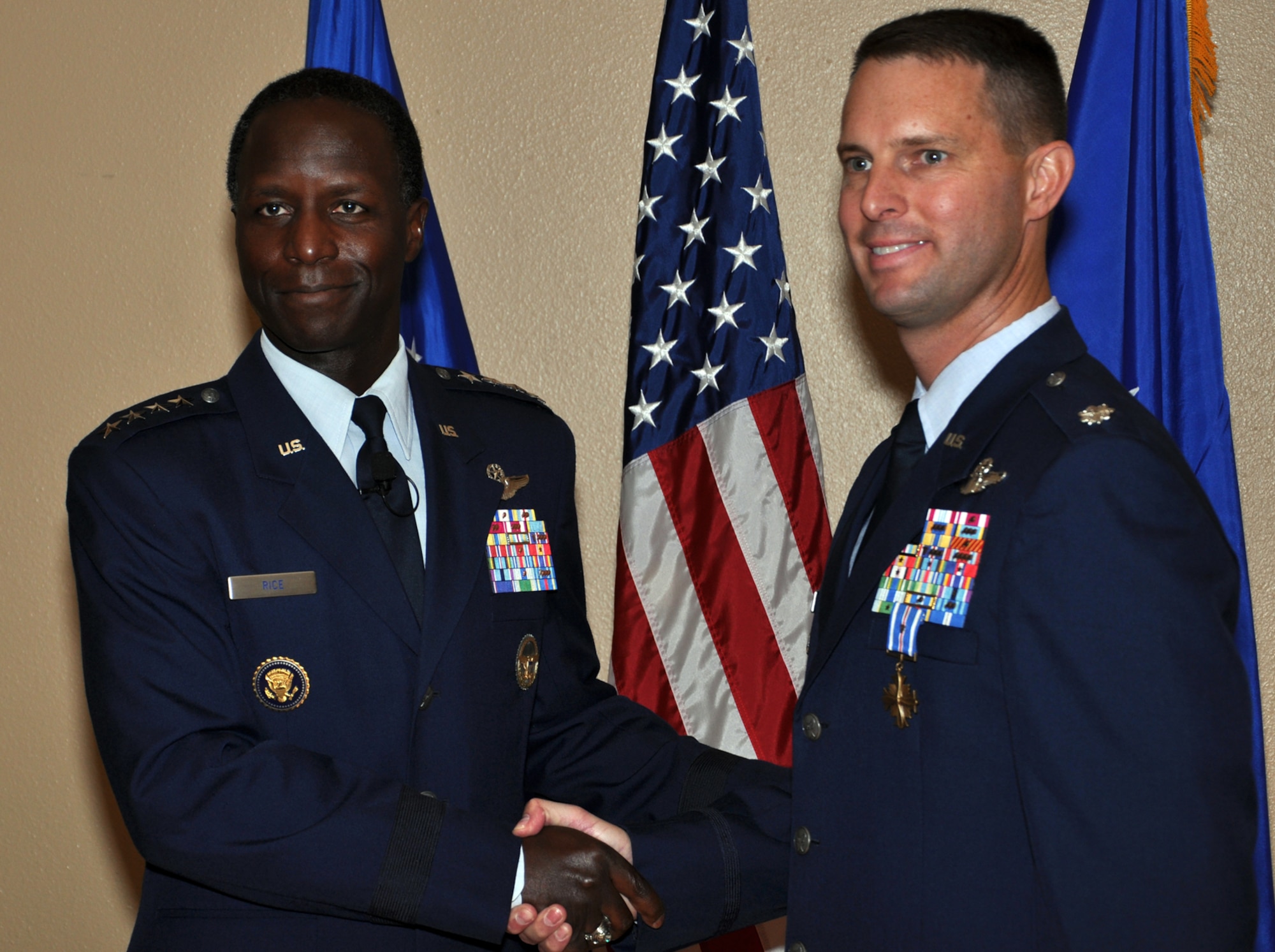 Gen. Edward A. Rice Jr., commander of Air Education and Training Command,
congratulates Lt. Col. Gregory Roberts, 19th Air Force, after presenting him
the Distinguished Flying Cross with valor at Randolph Air Force Base, Texas,
Nov. 9. Roberts earned the award for actions he took while rescuing more
than 1,000 people from severe flooding in Afghanistan in July 2010.
