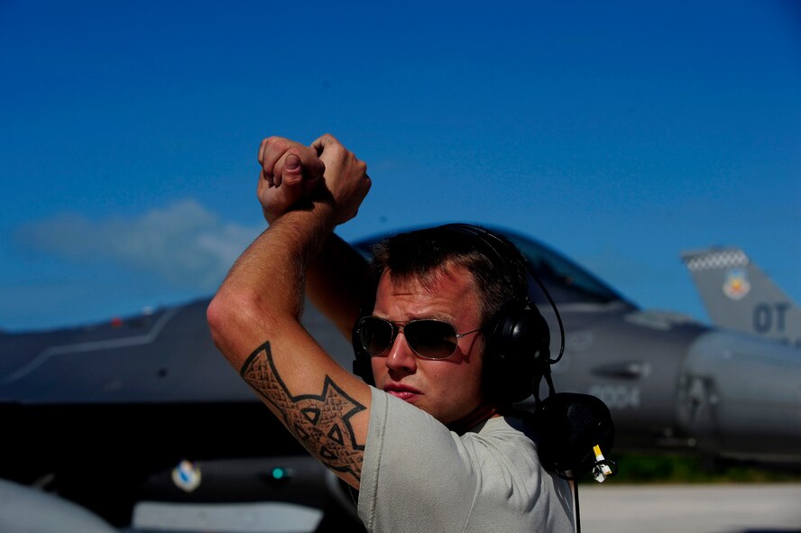 U.S. Air Force Staff Sgt. Leo Oliphant, assigned to the 46th Aircraft Maintenance Squadron (AMXS) as a crew chief, gives the signal to an F-16 Fighting Falcon pilot to hold breaks prior to departure in support of Exercise Vigilant Shield 12 at Naval Air Station Key West, Fla., Nov. 6, 2011. The exercise in Key West is the "first-ever proof of concept" for the military's Joint Deployable Integrated Air and Missile Defense System, a collection of high-end radars and missile systems as well as aircraft that work in tandem in the event of a threat to the continental United States.  The 46th AMXS is from Eglin Air Force Base, Fla.  (U.S. Air Force photo by Staff Sgt. Kamaile O. Long/Released)