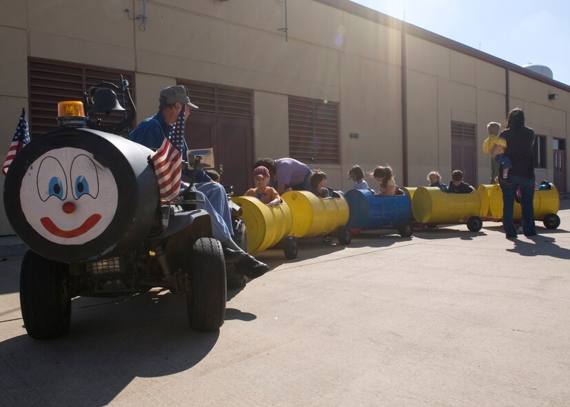 Children ride a train during the Fall Festival on Barksdale Air Force Base, La., Nov. 5. Children participated in activities such as arts and crafts, a bounce house and a train ride. (U.S. Air Force photo/Airman 1st Class Benjamin Gonsier)(RELEASED)