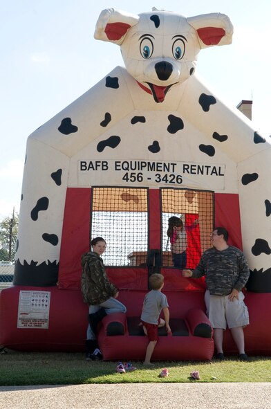Children play in a bounce house during the Fall Festival on Barksdale Air Force Base, La., Nov. 5. The festival offered activities for children including a bounce house, train rides and arts and crafts. (U.S. Air Force photo/Airman 1st Class Benjamin Gonsier)(RELEASED)