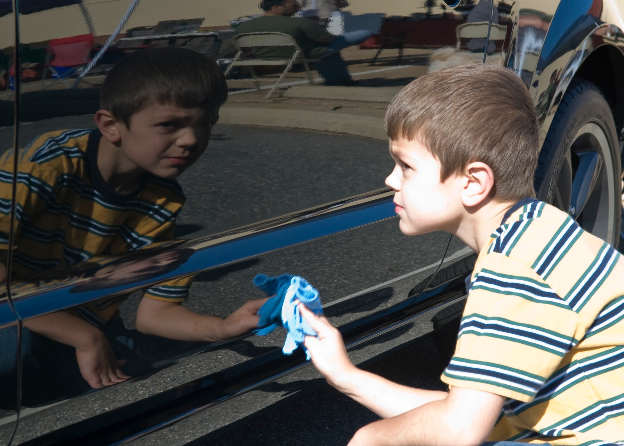 Luke Hargis, 8, son of Maj. Matthew Hargis, 2nd Operations Group, helps wash his father?s car on Barksdale Air Force Base, La., Nov. 5. Car enthusiasts were able to participate in a car show hosted at the Fall Festival. (U.S. Air Force photo/Airman 1st Class Benjamin Gonsier)(RELEASED)