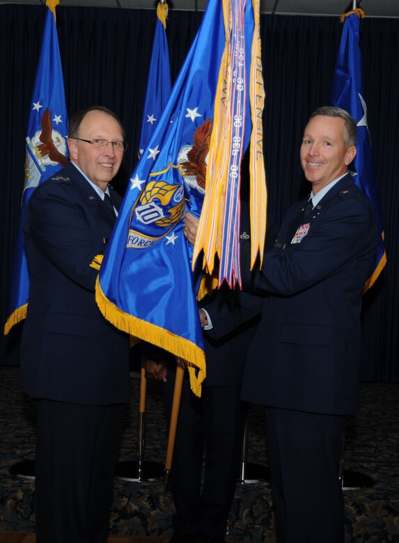 Lt. Gen. Charles Stenner, Jr., Chief of Air Force Reserve, Headquarters U.S. Air Force, Washington, D.C., and Commander, Air Force Reserve Command, Robins Air Force Base, Ga., passes the guidon to Brig Gen William Binger as he transfers command of Tenth Air Force located at the Naval Air Station Fort Worth Joint Reserve Base, Texas. Binger assumed command from Maj. Gen. Frank J. Padilla after two and a half years at 10th AF on Nov. 5.  