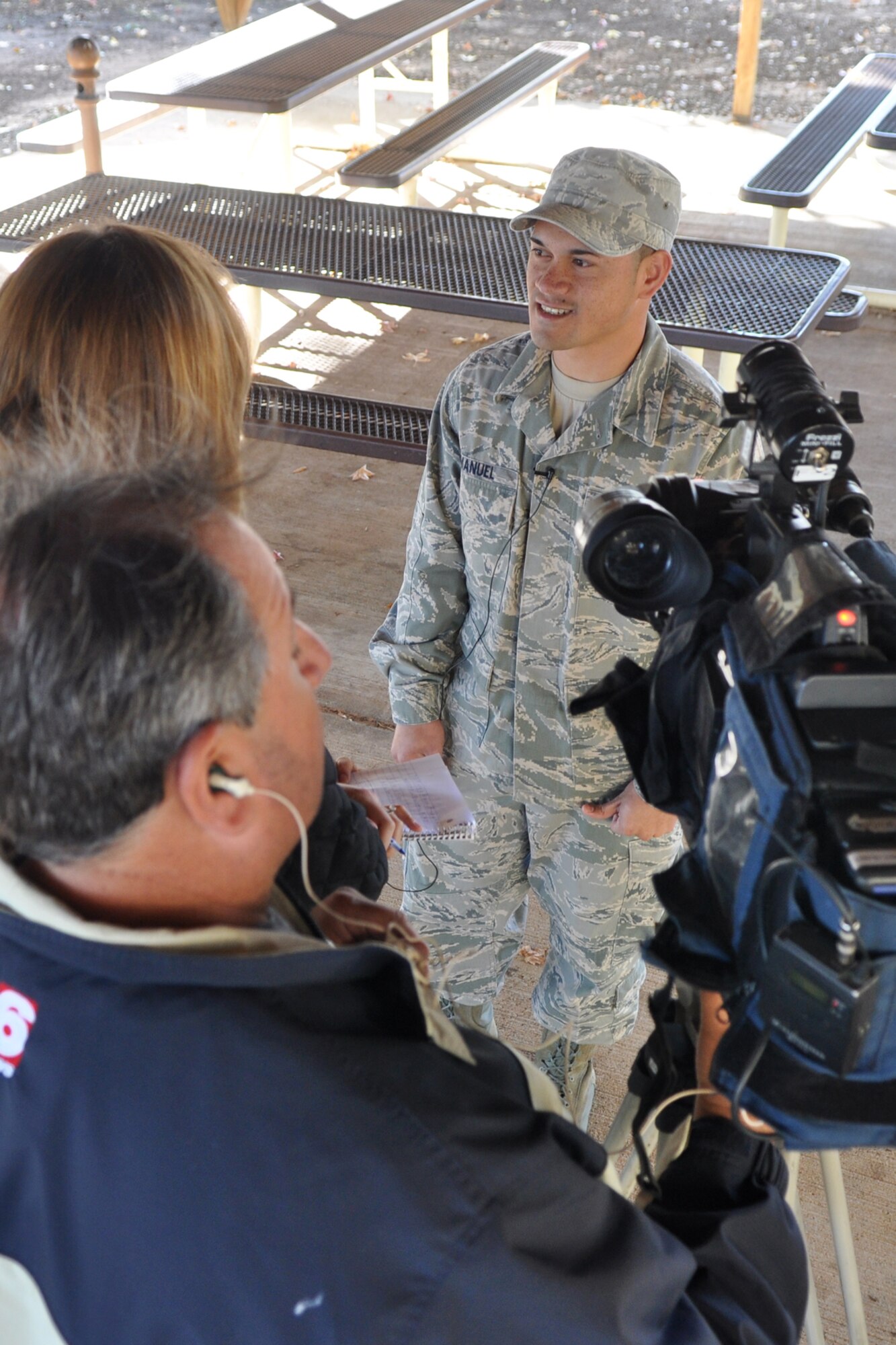 Cameraman Art Nerio checks sound as Senior Airman Fredy Imanuel, who is a knowledge operations manager assigned to the 2nd Maintenance Squadron, at Barksdale Air Force Base, La., explains what Veteran’s Day means to him Nov. 9, 2011. Nerio and Jenna Zibton, who is a reporter for KTAL Channel 6 in Shreveport, La., were at Barksdale to report on another story and decided to record several Airmen commenting about Veteran’s Day. (U.S. Air Force photo by Master Sgt. Jeff Walston/Released) 