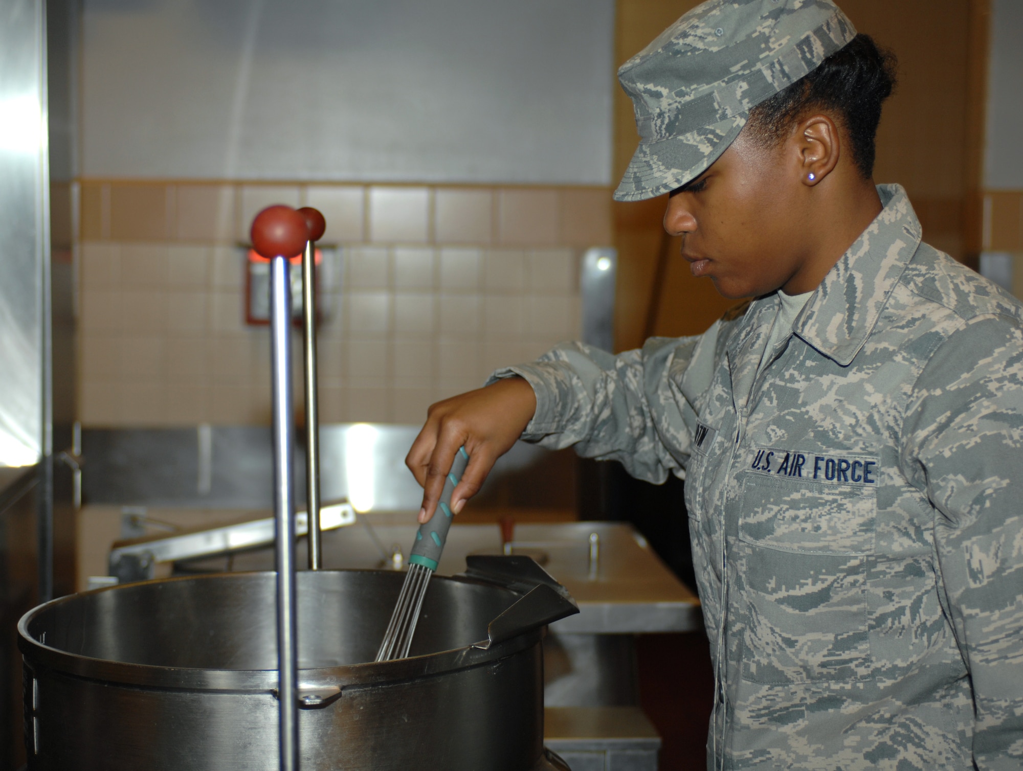U.S. Air Force Airman 1st Class Jasmin Martin, 355th Force Support Squadron food service apprentice, stirs soup during the lunch hour at the dining facility here at Davis-Monthan Air Force Base, Ariz., Nov. 9. (U.S. Air Force photo by Airman 1st Class Michael Washburn/Released)