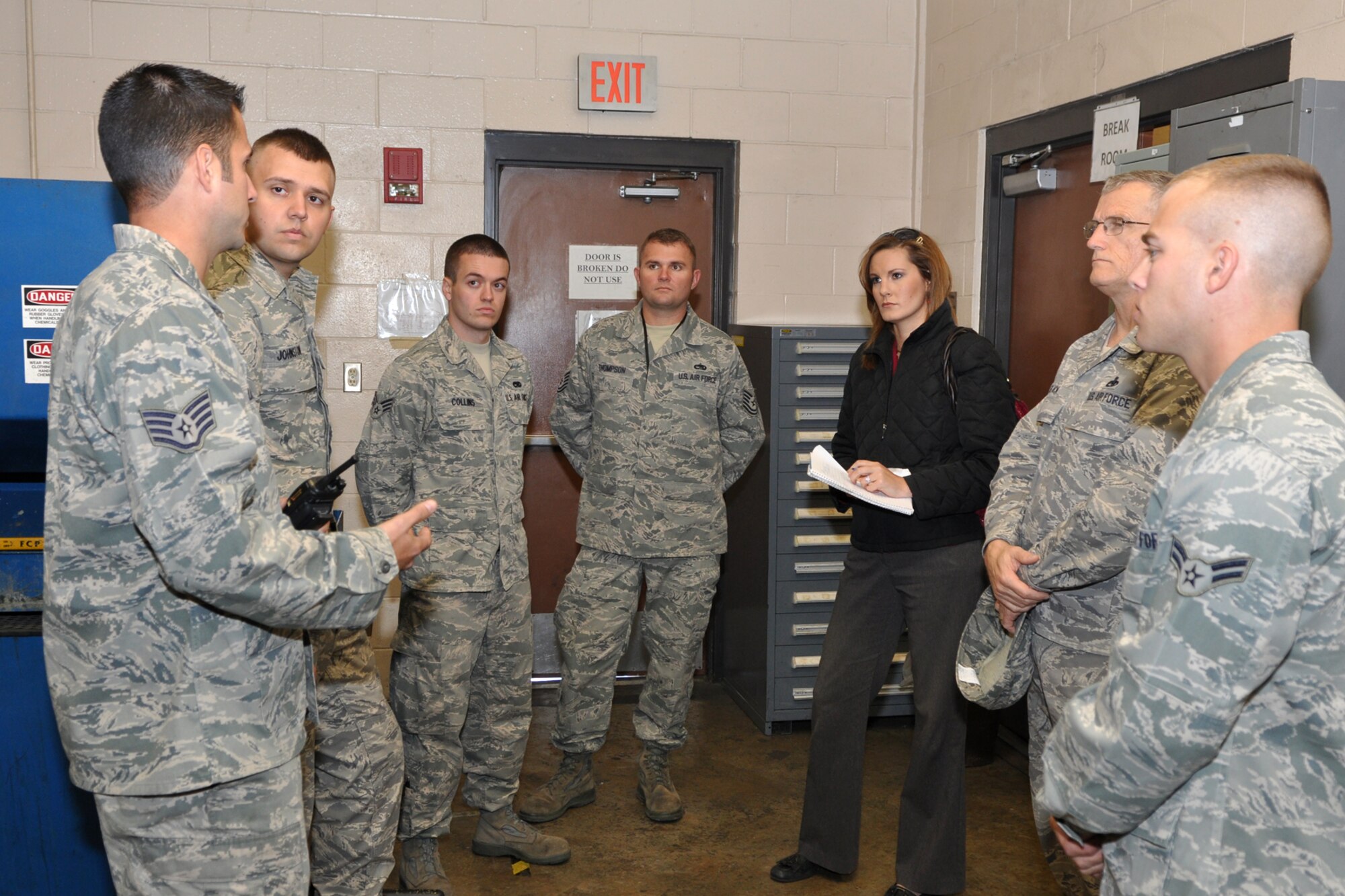 Staff Sgt. Byron Landon, who is a repair and reclamation technician assigned to the 707th Maintenance Squadron, explains an inspection evolution that is about to begin to Jenna Zibton, who is a reporter for KTAL Channel 6 in Shreveport, La., at Barksdale Air Force Base., La., Nov. 9, 2011. Zibton was at Barksdale to report on the working relationship between Airmen in 707th and 2nd Maintenance Squadrons at Barksdale. (U.S. Air Force photo by Master Sgt. Jeff Walston/Released) 