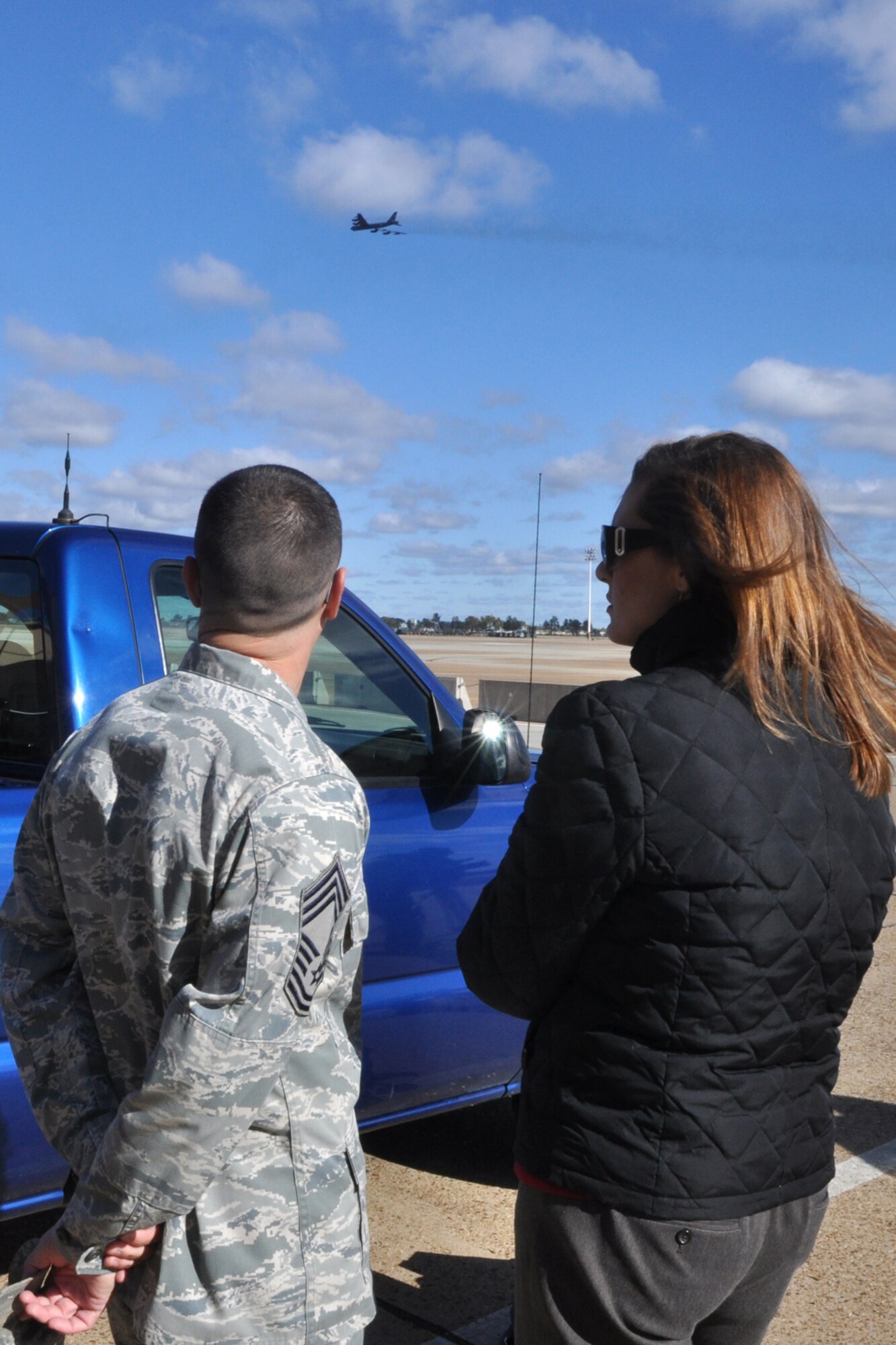 Chief Master Sgt. Eddy Young, who is the maintenance superintendent for the 707th Maintenance Squadron, discusses the working relationship between Airmen in 707th and 2nd Maintenance Squadrons with Jenna Zibton as a B-52 Stratofortress takes off at Barksdale Air Force Base, La., Nov. 9, 2011. Zibton, who is a reporter for KTAL Channel 6 in Shreveport, La., was at Barksdale to report on the total force concept that has been implemented at Barksdale. (U.S. Air Force photo by Master Sgt. Jeff Walston) 