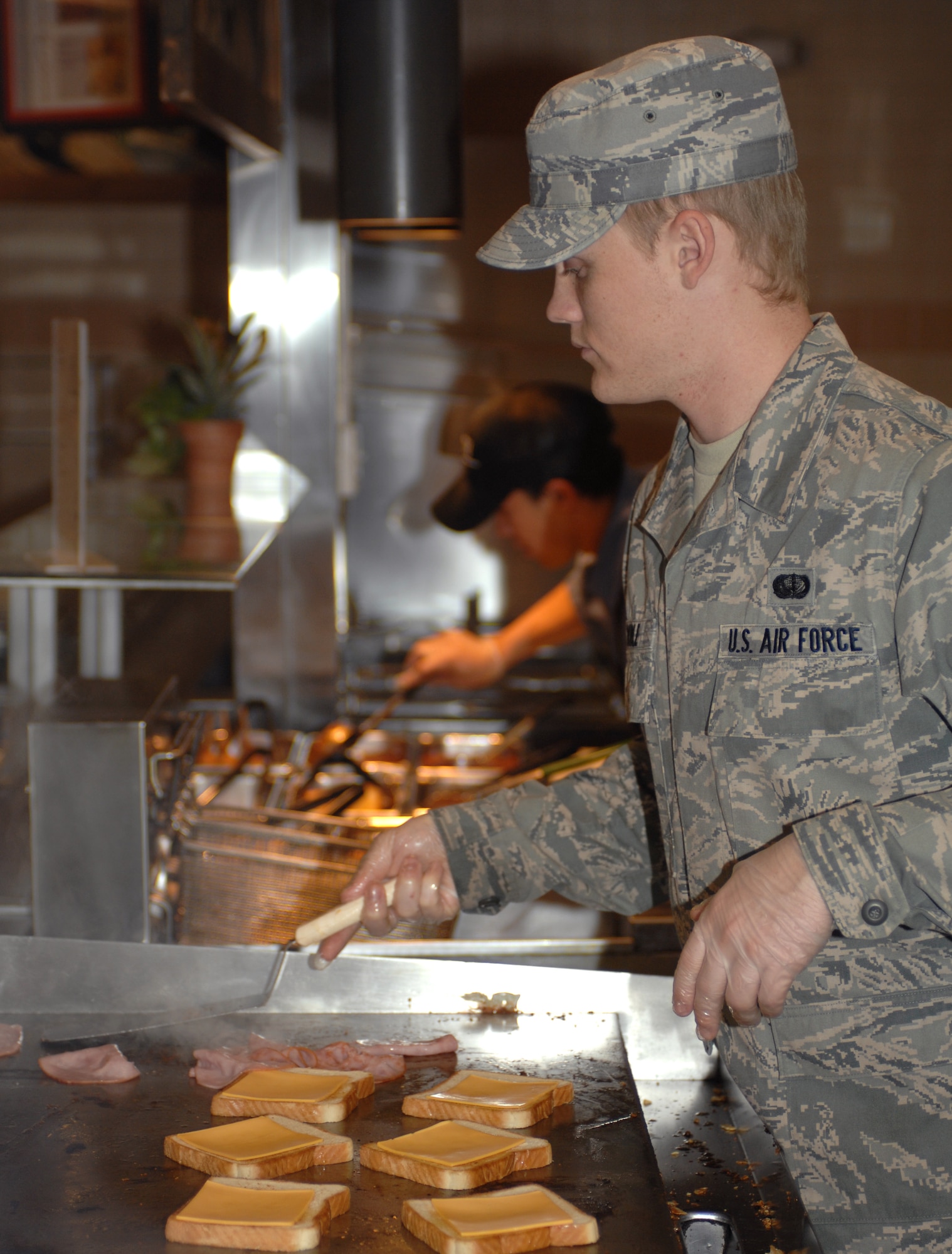 U.S. Air Force Airman 1st Class Kyle Noble, 355th Force Support Squadron food service apprentice, prepares ham and cheese sandwiches for hungry Airmen at the dining facility here at Davis-Monthan Air Force Base, Ariz., Nov. 9. (U.S. Air Force photo by Airman 1st Class Michael Washburn/Released)