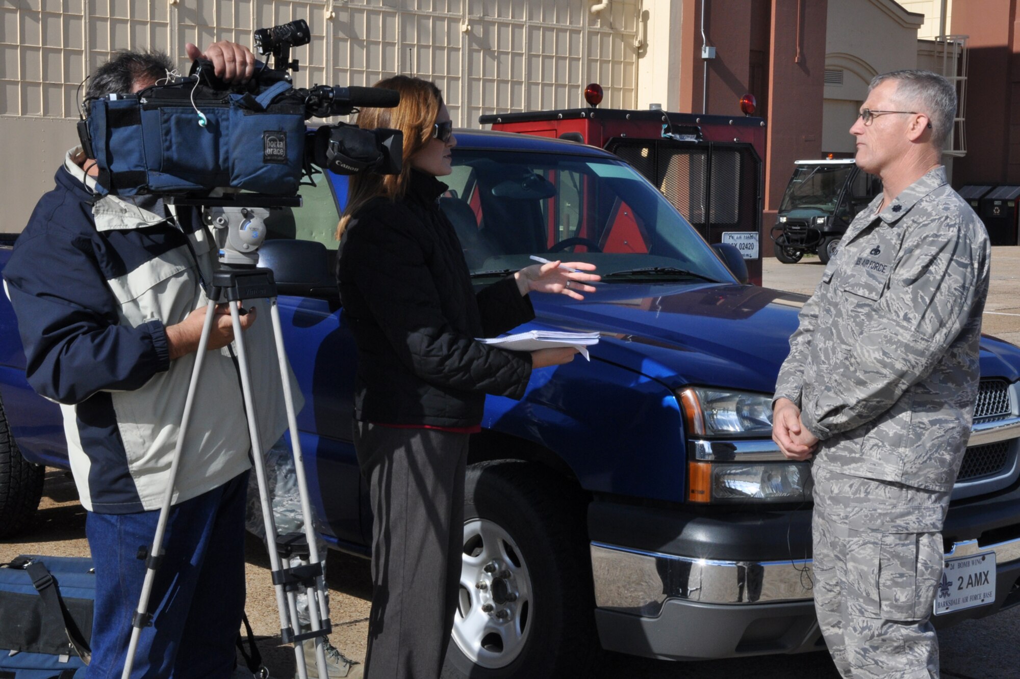 Lt. Col. Dwayne W. Slack, who is the commander of the 707th Maintenance Squadron, discusses the working relationship between Airmen in 707th and 2nd Maintenance Squadrons with Jenna Zibton at Barksdale Air Force Base, La., Nov. 9, 2011. Zibton, who is a reporter for KTAL Channel 6 in Shreveport, La., was at Barksdale to report on the total force concept that has been implemented at Barksdale. (U.S. Air Force photo by Master Sgt. Jeff Walston)