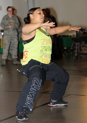 U.S. Air Force Tech. Sgt. Gina Ball, 319th Communications Squadron, dances to Zumba during a presentation at the Multicultural World Showcase on Nov. 9 on Grand Forks Air Force Base, N.D.  Members of the Grand Forks military community gathered to celebrate their diversity with educational booths, dance and music demonstrations and food from around the world.  (U.S. Air Force photo by Airman 1st Class Ashley N. Taylor)