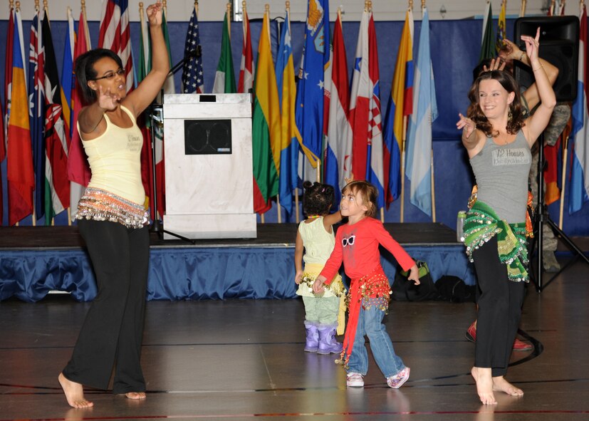 Children belly dance with Natasha Thomas and Jenna Solem, employees of The Twelve Houses, at the Multicultural World Showcase on Nov. 9 on Grand Forks Air Force Base, N.D.  Members of the Grand Forks military community gathered to celebrate their diversity with educational booths, dance and music demonstrations and food from around the world.  (U.S. Air Force photo by Airman 1st Class Ashley N. Taylor)