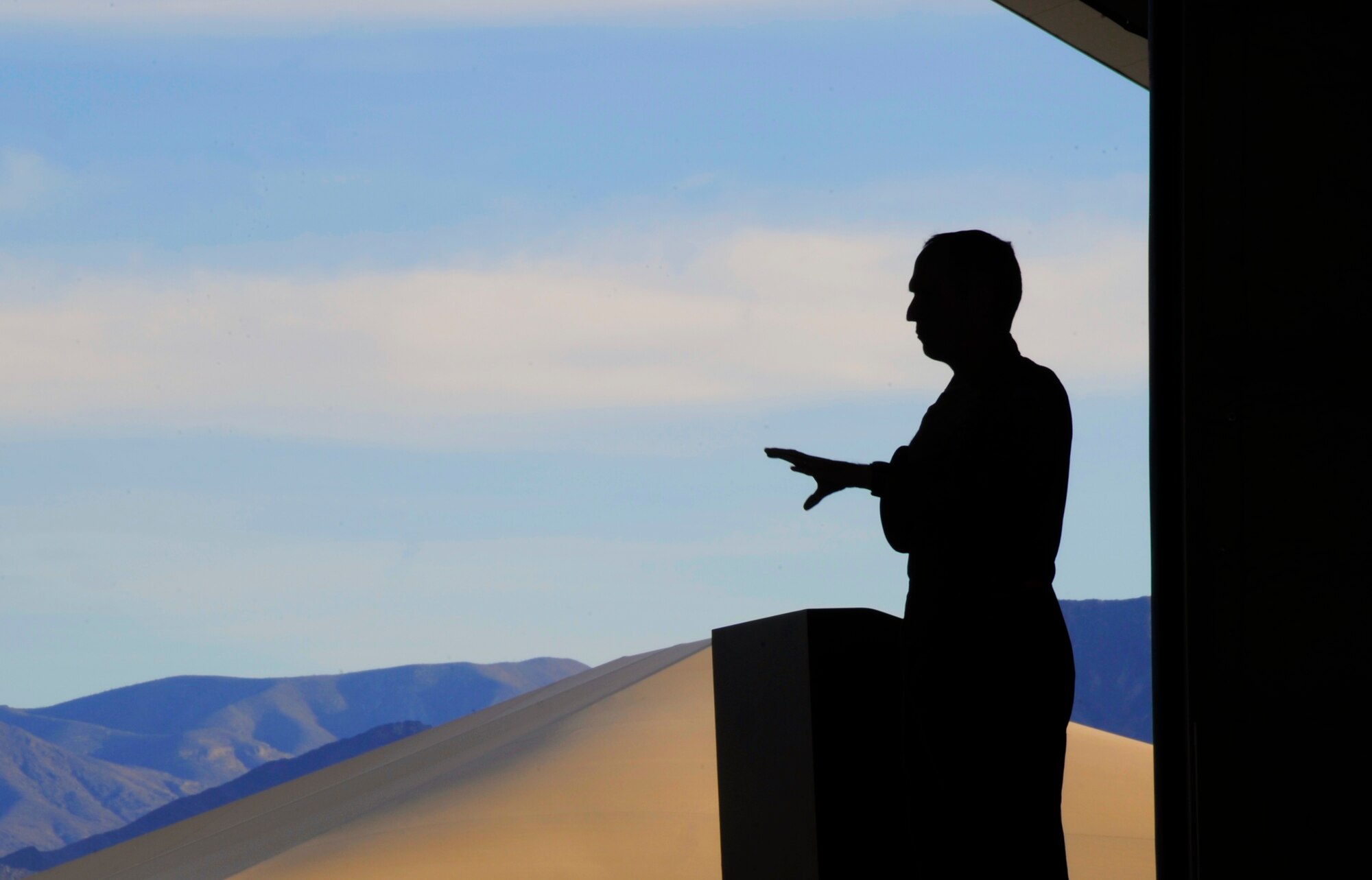 U.S. Air Force Gen. Mike Hostage, commander of Air Combat Command, stands amid a backdrop of the Nevada desert at Creech Air Force Base, Nev., Nov. 9 during a commander’s call. He addressed several concerns voiced by Airmen in a question-and-answer session and gave his vision for the future of ACC. (U.S. Air Force photo by 432nd AEW Public Affairs/Released).