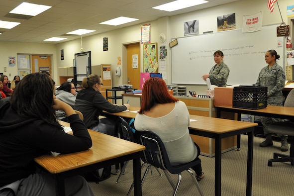 LIBERTY HIGH SCHOOL, Ohio -- Air Force Maj. Vicki Belleau, 910th Airlift Wing Staff Judge Advocate (active duty), and Air Force Reserve Tech. Sgt. Jessica Walker, a force management technician, assigned to the 910th Force Support Squadron, conduct an ethics training class for a group of students here, Nov. 10, 2011. The Citizen Airmen, based at nearby Youngstown Air Reserve Station, Ohio, were demonstrating how the high school students can use ethics, the standards that help determine what is good, right and proper, in their day-to-day lives as part of "Excellence through Ethics Day," a program by Junior Achievement of Mahoning Valley, a civic organization with the goal of empowering young people to own their economic success. U.S. Air Force photo by Master Sgt. Bob Barko Jr.