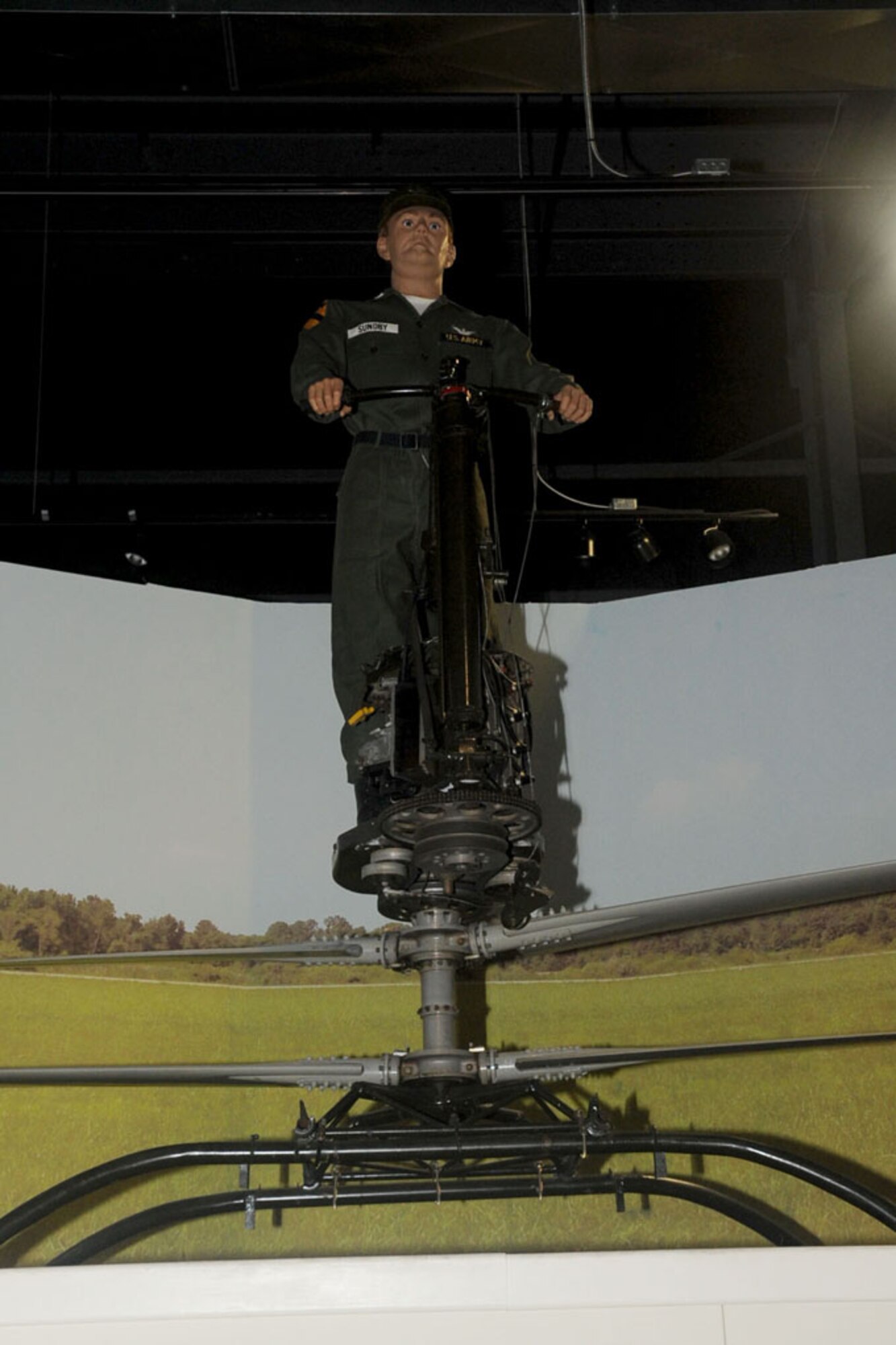 A Soldier stands on top of one of the first de Lackner Aerocycles at the U.S. Army Transportation Museum at Fort Eustis. (U.S. Air Force photo by Staff Sgt. Ashley Hawkins/Released)