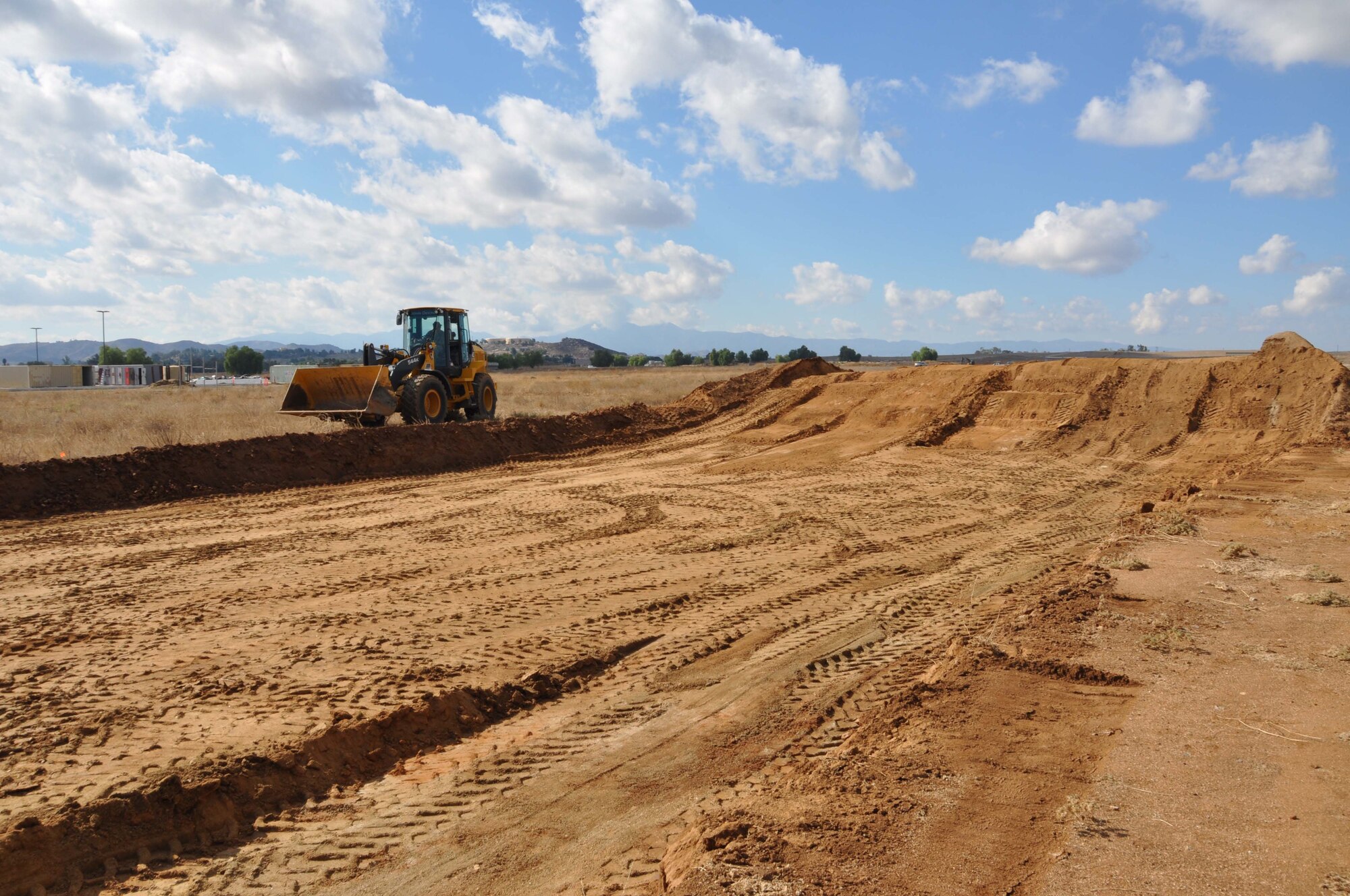 Tech. Sgt. Gary Glaze, 452nd Civil Engineer Squadron, operates a front loader, Nov. 5, 2011, to prepare one of five mud pits for the Defenders Dash Mud Run, scheduled for Nov. 19 at the Ben Clark Joint Training Center, Riverside, Calif.  According to the organizers, this pit is the largest mud pit in Southen California.  (U.S. Air Force photo/Master Sgt. Linda Welz) 