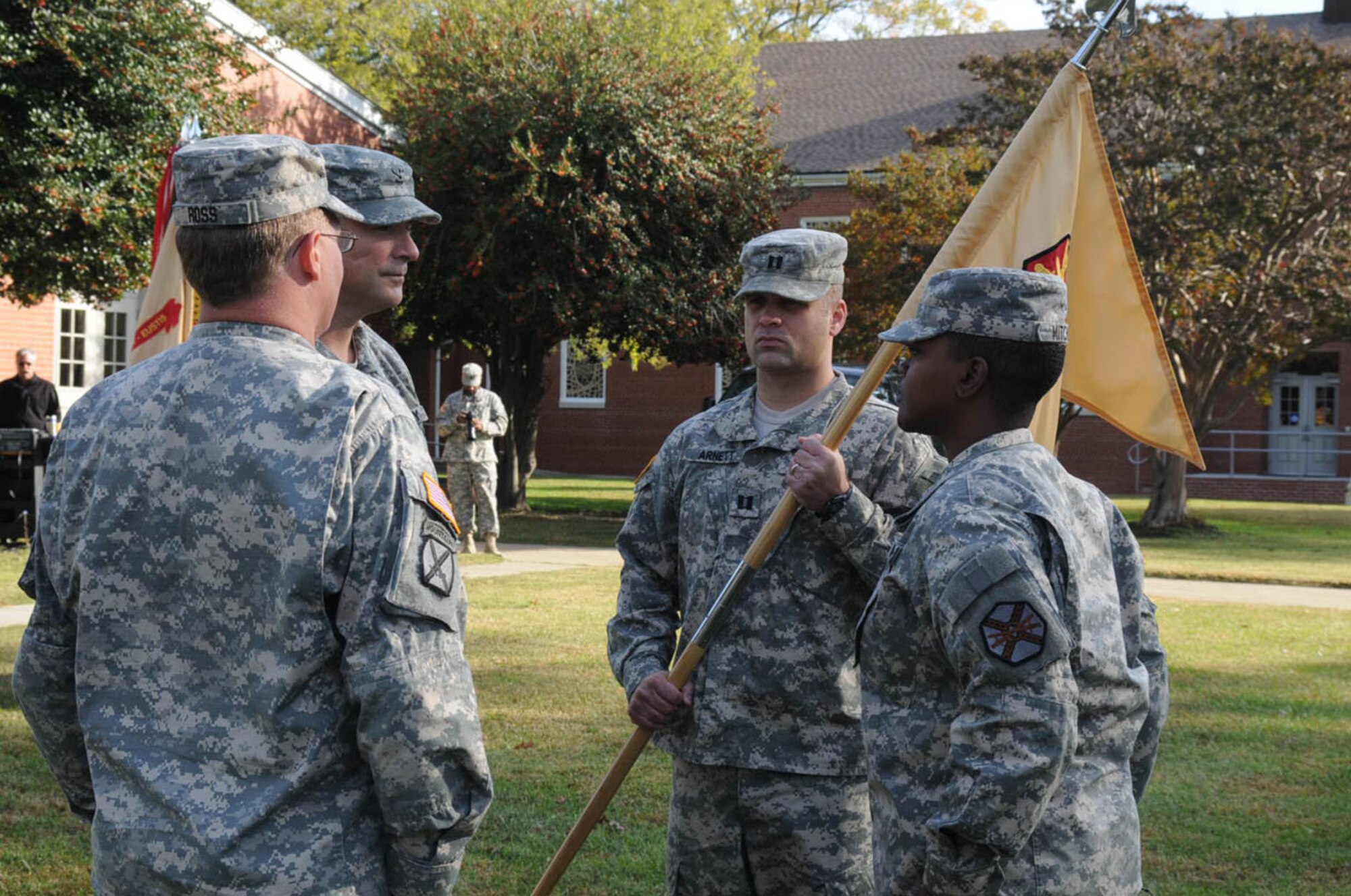 Capt. Samuel A. Arnett, Army Support Activity, Headquarters and Headquarters Company incoming commander, receives the guidon from Capt. Robert E. Ross, outgoing commander, during the ASA, HHC, change of command ceremony outside the Regimental Memorial Chapel Nov 4. (U.S. Air Force photo by Tetaun Moffett/Released)