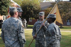 Capt. Samuel A. Arnett, Army Support Activity, Headquarters and Headquarters Company incoming commander, receives the guidon from Capt. Robert E. Ross, outgoing commander, during the ASA, HHC, change of command ceremony outside the Regimental Memorial Chapel Nov 4. (U.S. Air Force photo by Tetaun Moffett/Released)