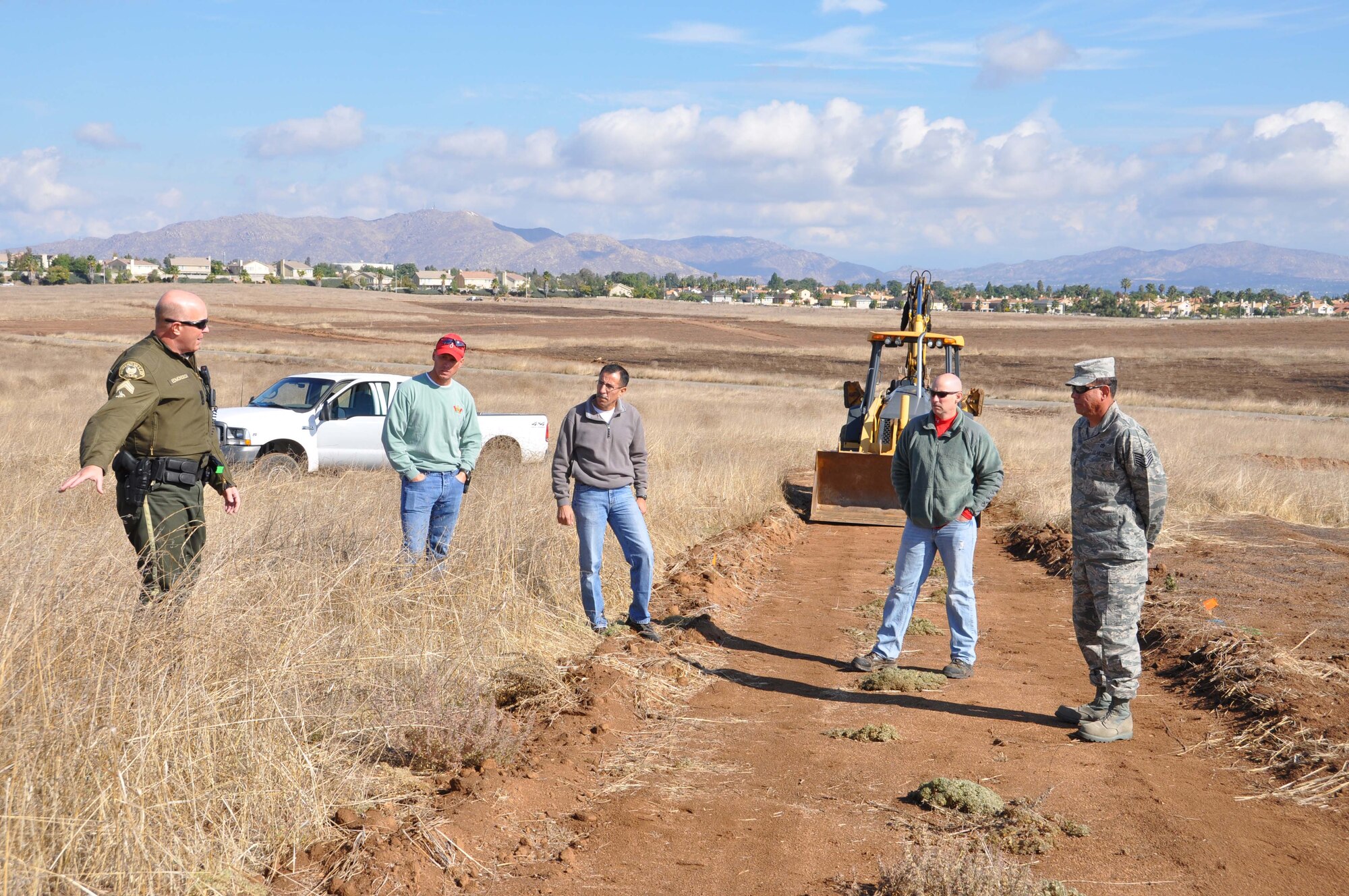 (from left) Cpl. Jason Edmondson, Moreno Valley Police Dept., discusses the location of one of the Defenders Dash obstacles with Sgt. Tim Elwell and Deputy Paul Sandoval, Riverside Sheriff's Dept., Capt. Al Knapp, March Company Grade Officers' Council vice president, and Tech. Sgt. Oscar Rivera, 452nd Civil Engineer Squadron.  (U.S. Air Force photo/Master Sgt. Linda Welz)