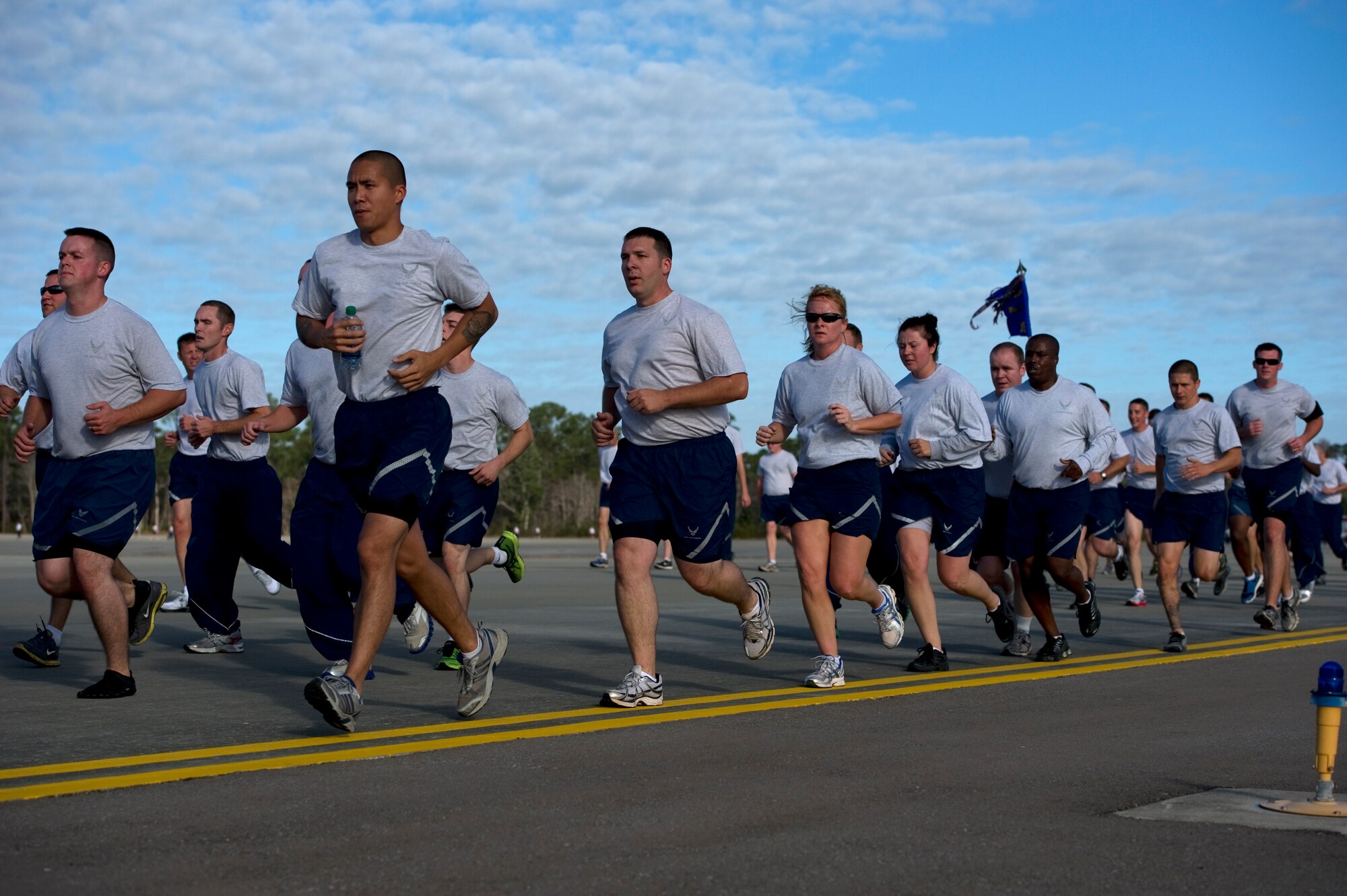 U.S. Air Force Airmen take to the flight-line pavement during the 5 km base-wide run, Hurlburt Field, Fla., Nov. 7, 2011.  Air Force Special Operations Command Airmen ran as one team to promote unity among the base. (U.S. Air Force photo/Airman 1st Class Naomi Griego)(Released)