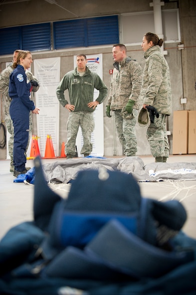 Cadet 2nd Class Erin Brown, U.S. Air Force Academy, briefs 23rd Wing members from Moody Air Force Base, Ga., on the parachute training program during a tour of the U.S. Air Force Academy, Colorado Springs, Colo., Nov. 4, 2011. The program has two stages, the first stage, Wings of Green, consists of lowerclassmen and is where cadets receive their basic parachute jump training. The second stage, Wings of Blue, consists of upperclassmen and cadets train the lower class as well as perform in teams for sports events and competitions. The Air Force Academy has one of the only programs that allows the very first jump by its students to be tandem-free. (U.S. Air Force Photo by Staff Sgt. Joshua J. Garcia/Released)