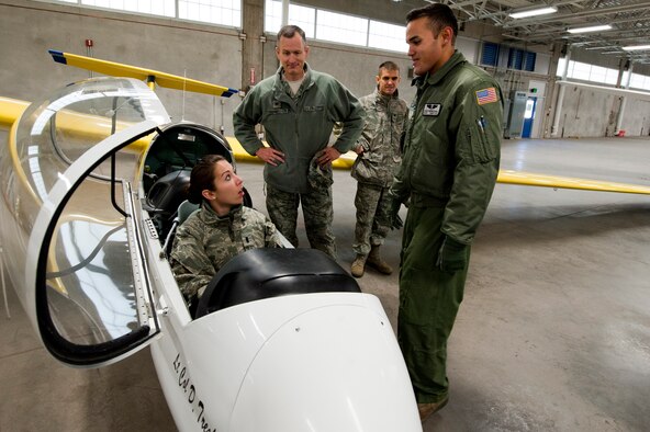 U.S. Air Force Cadet 2nd Class Carlos Berreteaga, academy glider pilot for the U.S. Air Force Academy, Colorado Springs, Colo., briefs U.S. Air Force 1st Lt. Jennifer Matthews, 23rd Force Supports Squadron, and U.S. Air Force Col. Billy Thompson, 23rd Wing Commander, both from Moody Air Force Base, Ga., about the glider aerobatics team during an academy tour, Nov. 4, 2011. Throughout the program cadets learn how to fly gliders and will earn their aeronautical wings. The upperclassmen cadets also compete in national and international competitions throughout their stay at the academy.  (U.S. Air Force Photo by Staff Sgt. Joshua J. Garcia/Released)