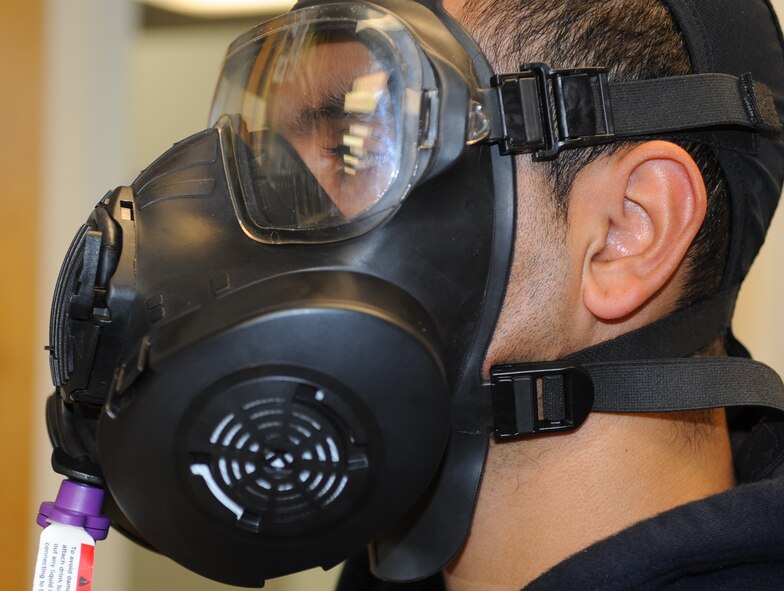 Airman 1st Class Carlos Santiago, 4th Force Support Squadron food service apprentice, performs a gas mask fit test at Seymour Johnson Air Force Base, Nov. 10, 2011. The fit test ensures that the overall fit and seal of the mask is good for operational use. Santiago hails from Bayamon, Puerto Rico. (U.S. Air Force photo by Senior Airman Gino Reyes)
