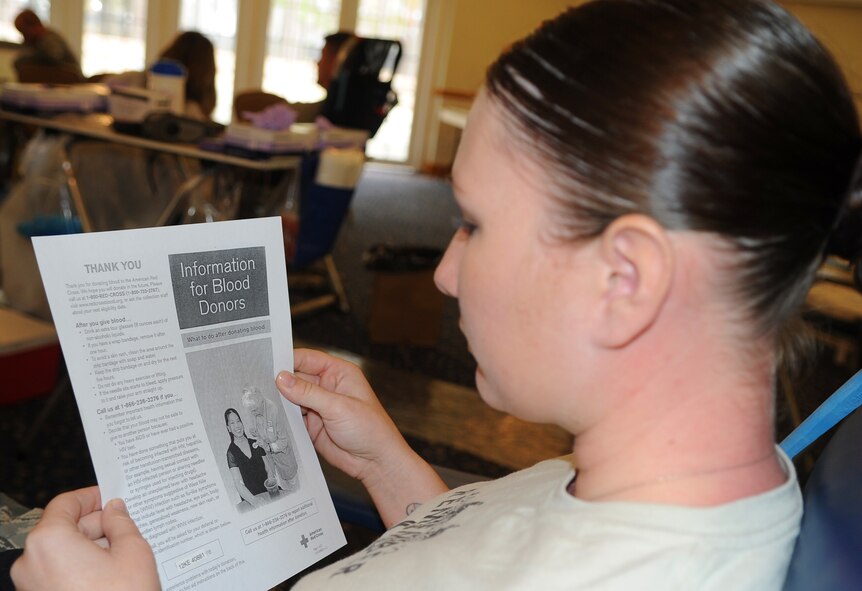 Staff Sgt. Jennifer Nedzweckas, 4th Security Forces Squadron vehicle control officer, reads information about giving blood prior to donating to the American Red Cross at Seymour Johnson Air Force Base, Nov. 10, 2011. Every donator will be prescreened prior to giving blood to ensure that their blood is good. Nedzweckas hails from St. Roberts, Mo. (U.S. Air Force photo by Senior Airman Gino Reyes)