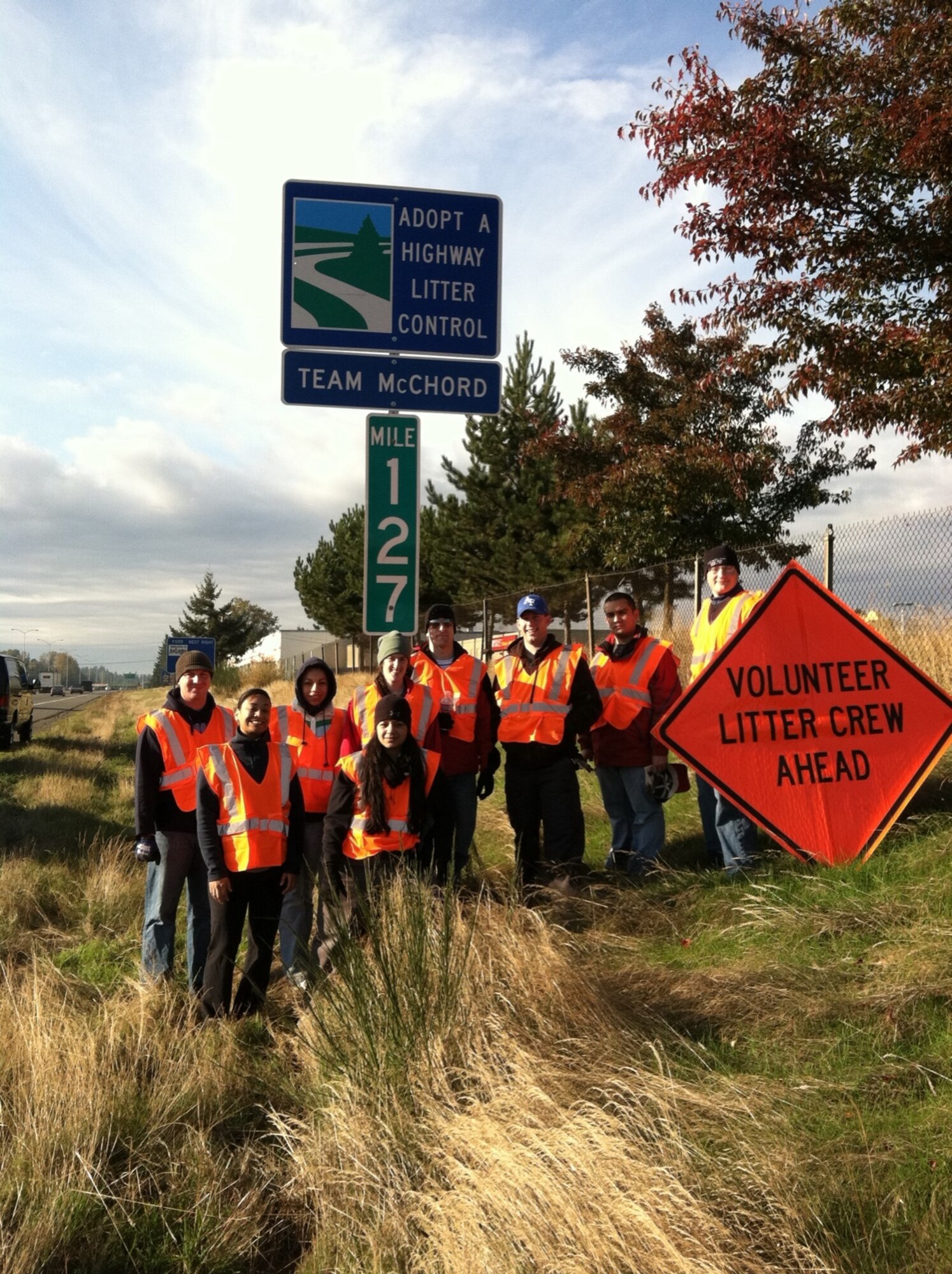 Ten volunteer company grade officers pose for a picture after picking up litter as part of the Adopt-A-Highway program Nov. 7, 2011, in Tacoma, Wash. Per their agreement with the Washington State Department of Transportation, the Company Grade Officer Council is required to pick up litter on an assigned stretch of highway four times a year for the next four years. This opportunity allows members of the council to consistently take care of the earth, serve the community and promote a good cause. (U.S. Air Force courtesy photo)
