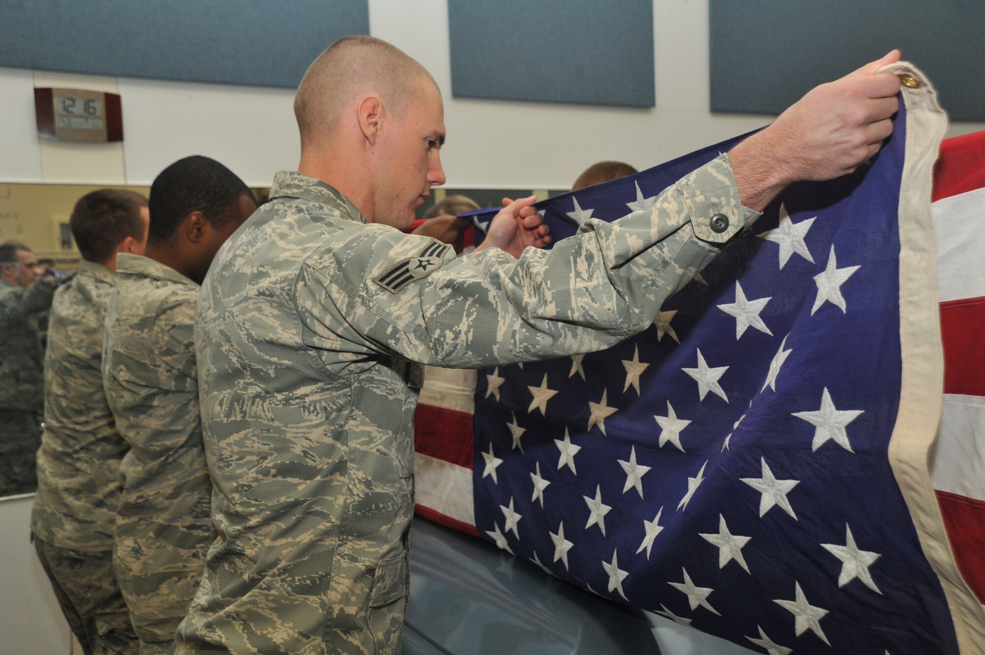 Fairchild Honor Guard members perform a six-man flag fold during their training hours Oct. 28. During the honors of a funeral service of a fallen veteran, the flag is folded in honor of the deceased and is presented to the next-of-kin. (U.S. Air Force photo/Airman 1st Class Tyirez Frost))