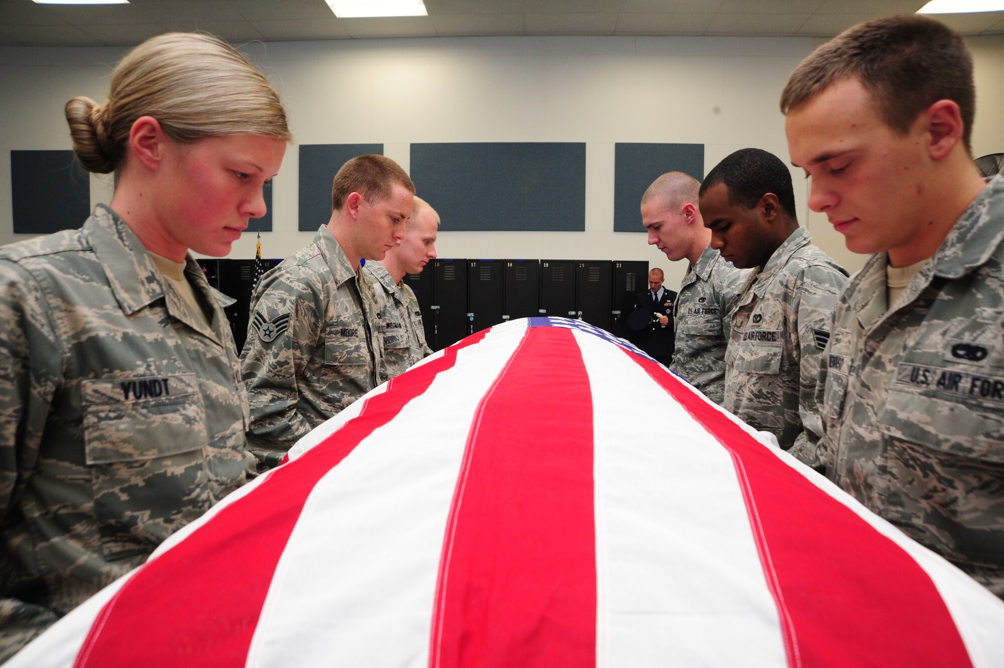 Fairchild Honor Guard members perform a six-man flag fold during their training hours Oct. 28. The Body Bearers element participates in U.S. Air Force, joint service and state funerals by carrying the remains of deceased service members and their dependents to their final resting places. (U.S. Air Force photo/Airman 1st Class Taylor Curry)