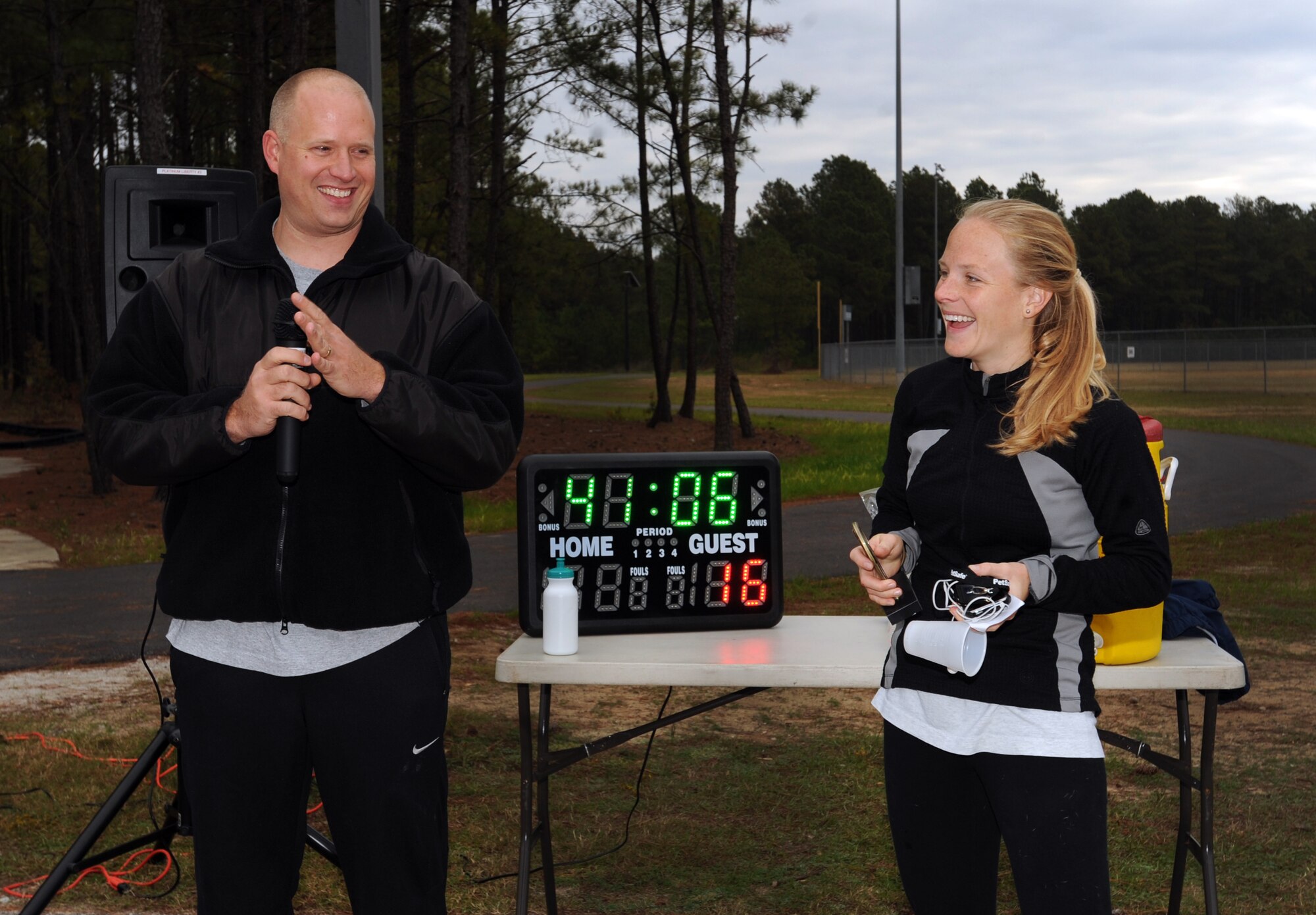 U.S. Air Force Tech. Sgt. Mark Waldron, 20th Equipment Maintenance Squadron unit deployment manager, awards Bethany Duncan, 20th Force Support Squadron aerobics instructor, the first place award at the end of the 5K Combined Federal Campaign run, Shaw Air Force Base, S.C., Nov. 10, 2011. This year is "50 years of caring" for the CFC. CFC is an annual drive which is based on one idea for one gift, once a year. Its purpose is to "improve quality of local community, nation, and world," President John F. Kennedy 1961. This year's goal is to reach $175,000. (U.S. Air Force photo by Airman 1st Class Tabatha Duarte/Released)