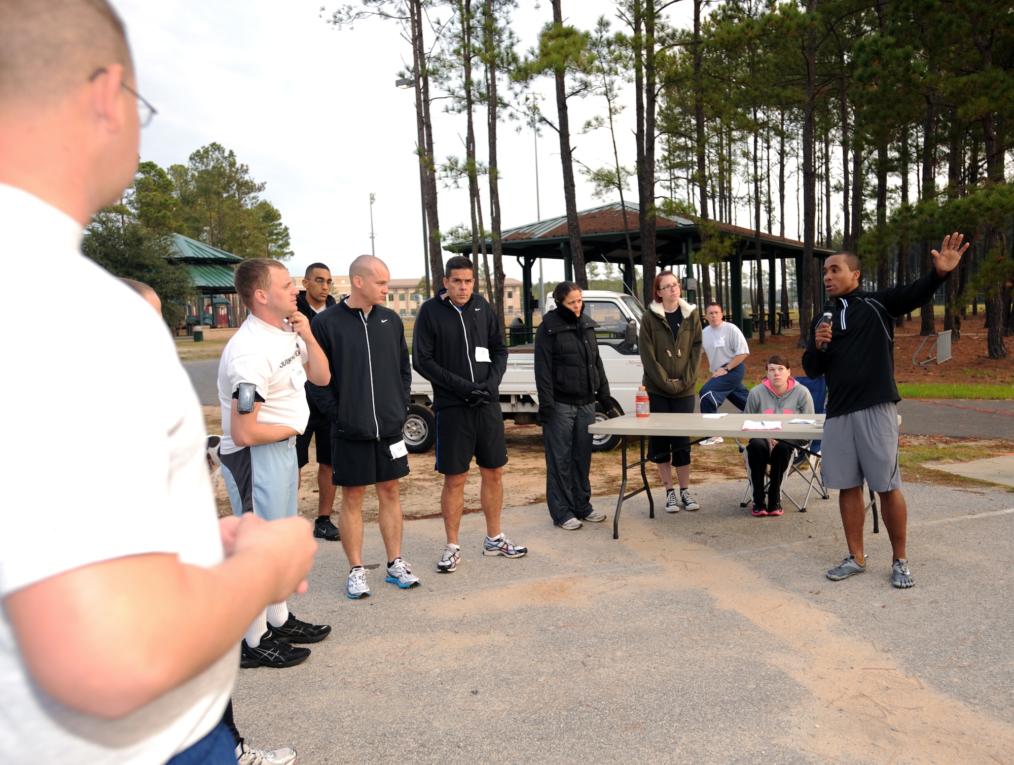 U.S. Air Force Staff Sgt. Perris Coleman, 20th Equipment Maintenance Squadron unit fitness program manager, speaks to runners about the Combined Federal Campaign and thanks them for coming out and  supporting the event, Shaw Air Force Base, S.C., Nov. 10, 2011. This year is "50 years of caring" for the CFC. CFC is an annual drive which is based on one idea for one gift, once a year. Its purpose is to "improve quality of local community, nation, and world," President John F. Kennedy 1961. This year's goal is to reach $175,000. (U.S. Air Force photo by Airman 1st Class Tabatha Duarte/Released)