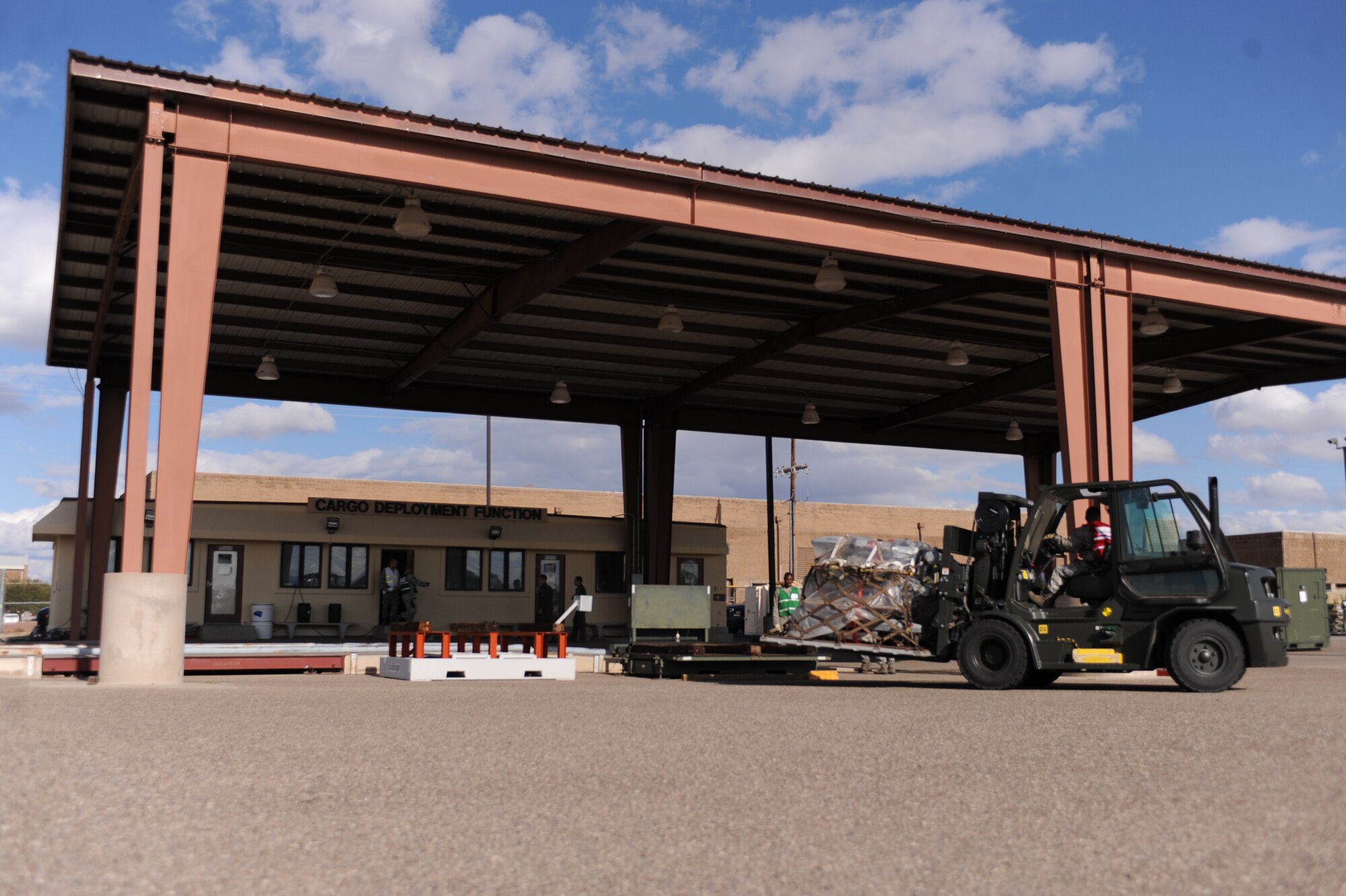 U.S. Air Force Airmen from the 355th Fighter Wing work in front of the Cargo Deployment Function Building during the operational readiness exercise on Davis-Monthan Air Force Base, Ariz., Nov. 7, 2011. (U.S. Air Force photo by Airman 1st Class Christine Griffiths/Released)