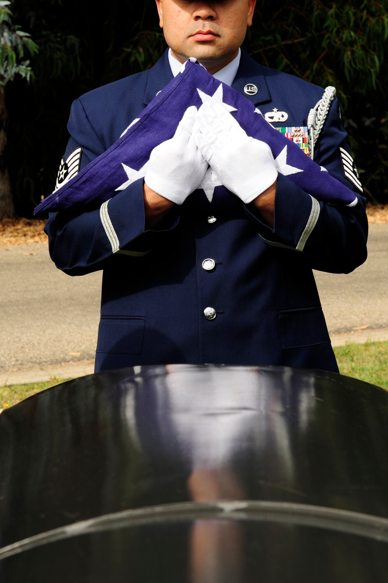 VANDENBERG AIR FORCE BASE, Calif.-- A member of the base honor guard holds the flag during a funeral practice at the Lompoc Evergreen Cemetery here Tuesday, Sept. 20, 2011. The rendering of military funeral honors is a way to show the nation’s deep gratitude to those who, in times of war and peace, have faithfully defended the county.  (U.S. Air Force photo/Senior Airman Lael Huss)
