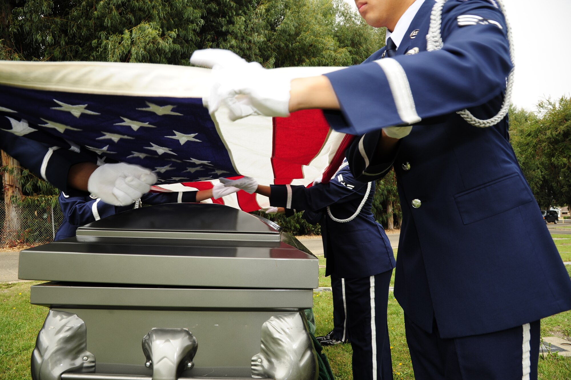 VANDENBERG AIR FORCE BASE, Calif. - Members of the base honor guard fold the American flag during a 10-man funeral practice at the Lompoc Evergreen Cemetery here Tuesday, Sept. 20, 2011. The rendering of military funeral honors is a way to show the nation’s deep gratitude to those who, in times of war and peace, have faithfully defended the county.  (U.S. Air Force photo/Senior Airman Lael Huss)
