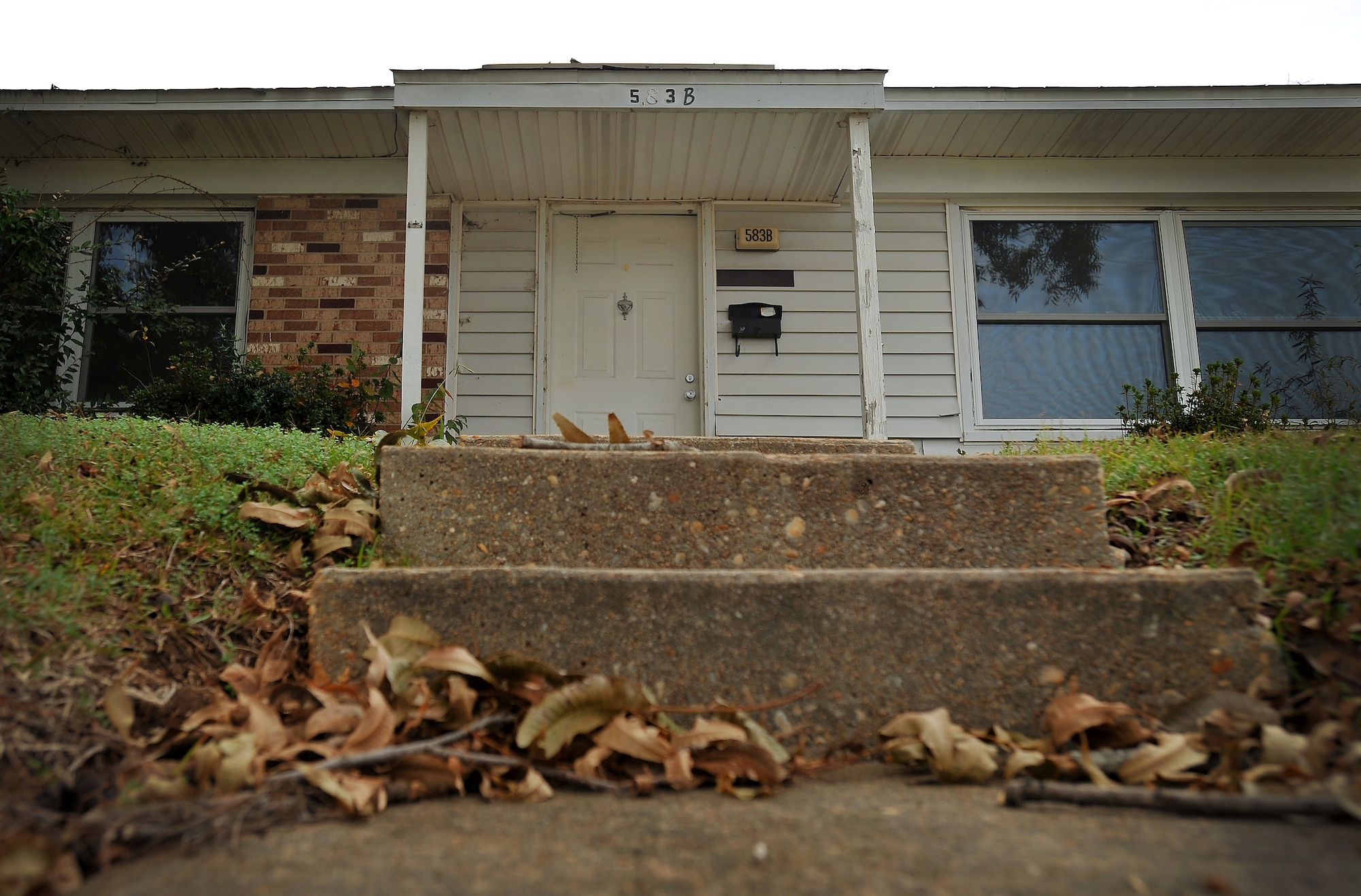 Fall leaves and other debris collect around the front steps of house 583 as the condemned quarters sit vacant, Nov. 10, 2011, Shaw Air Force Base, S.C. House 583 will be amongst the first houses to be demolished on Nov. 14, 2011, during a family housing redevelopment commencement ceremony signifying the beginning of a family housing privatization redevelopment project. (U.S. Air Force photo by Senior Airman Kenny Holston/Released)


