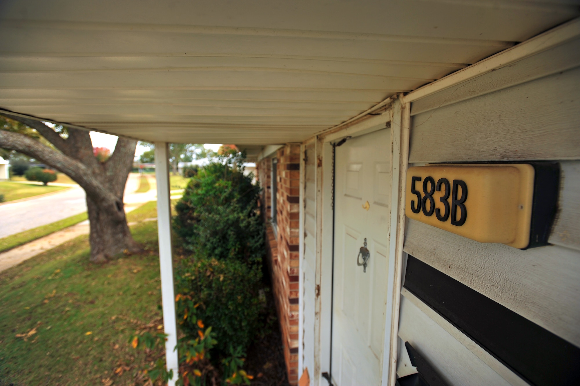 Address numbers for house 583 dry-rot and crack as the condemned quarters sit vacant, Nov. 10, 2011, Shaw Air Force Base, S.C. House 583 will be amongst the first  houses to be demolished on Nov. 14, 2011, during a family housing redevelopment commencement ceremony signifying the beginning of a family housing privatization redevelopment project. (U.S. Air Force photo by Senior Airman Kenny Holston/Released)


