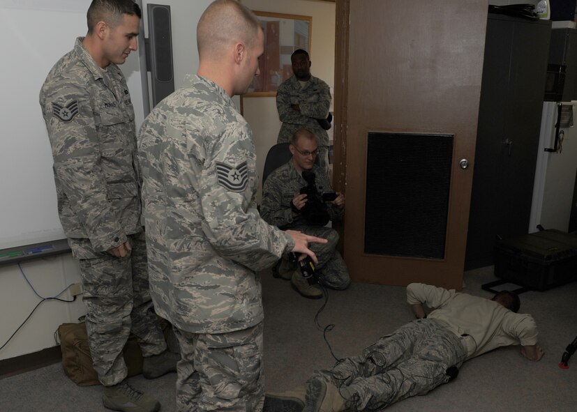 Airman 1st Class Jason Utley, 7th Security Forces Squadron, gets tased during training Nov. 9, 2011 at Dyess Air Force Base, Texas. Training is conducted annually to ensure 7 SFS airmen are qualified to use a taser. (U.S. Air Force photo by Airman 1st Class Jonathan Stefanko/ Released) 